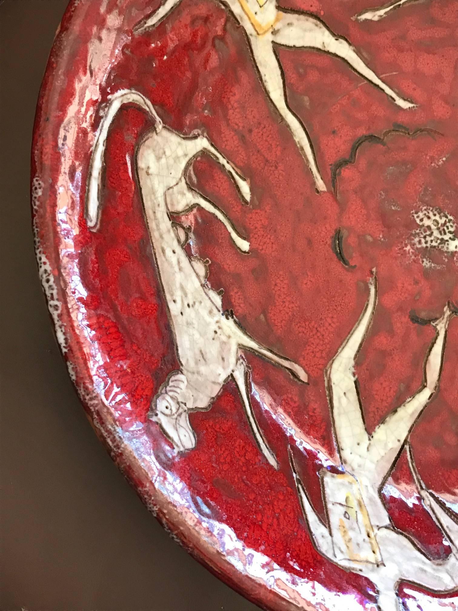 A fantastic and rare ceramic charger by Eugenio Pattarino. Vibrant red color and Classic Italian Mid-Century style is represented very well in this piece. Eugenio Pattarino was born in 1885 and passed away in 1971. He was a master sculptor and model