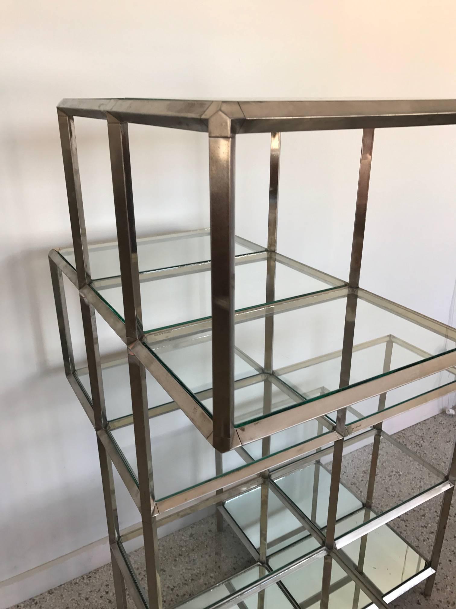 An unusual German (marked made in West Germany), chrome-plated etagere-display unit. Two identical available, priced separately. Lower shelves are mirrored glass-the rest are clear.