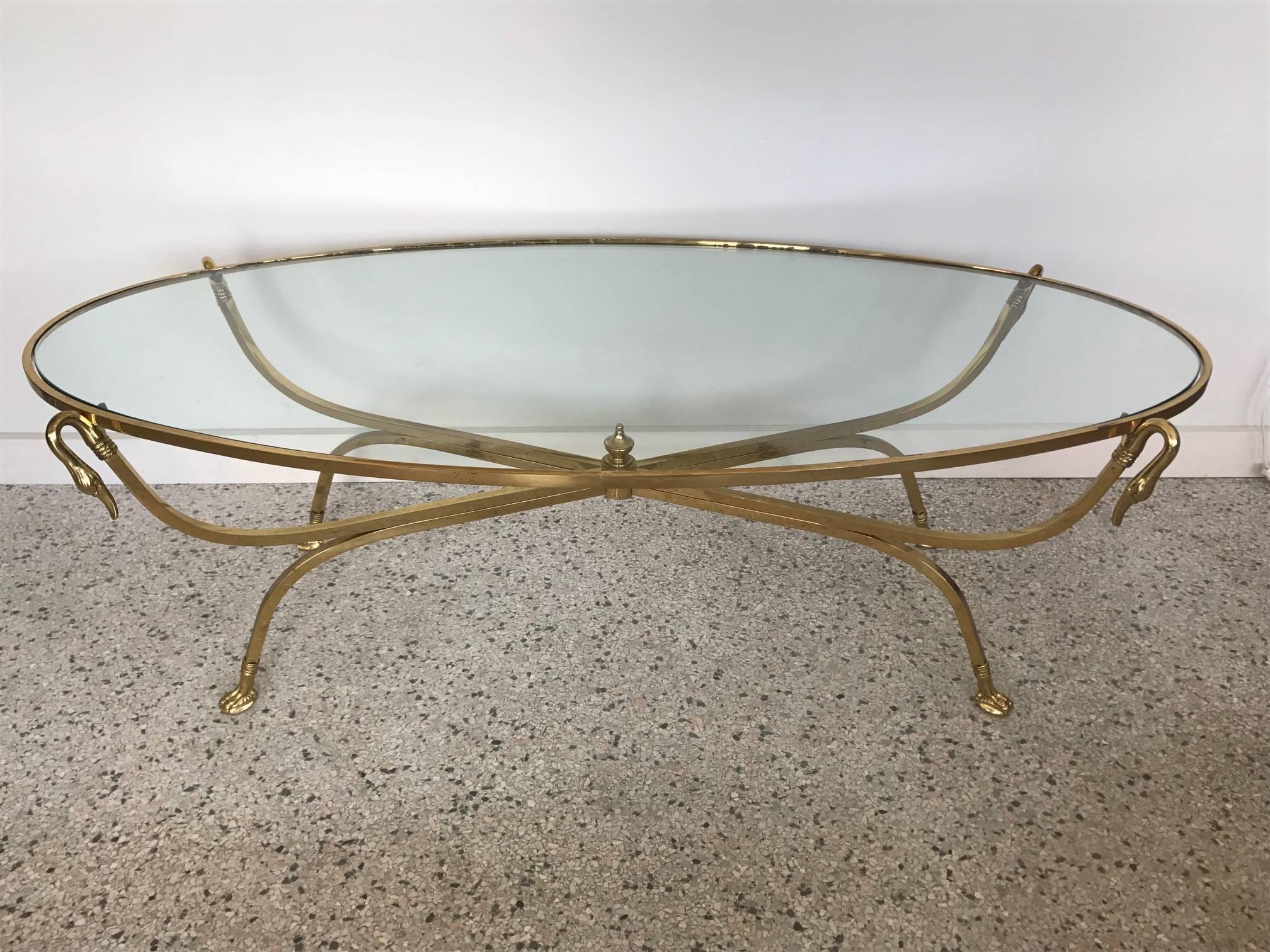 A chic and elegant 1970s Italian brass swan coffee table with original glass. Well made and heavy.