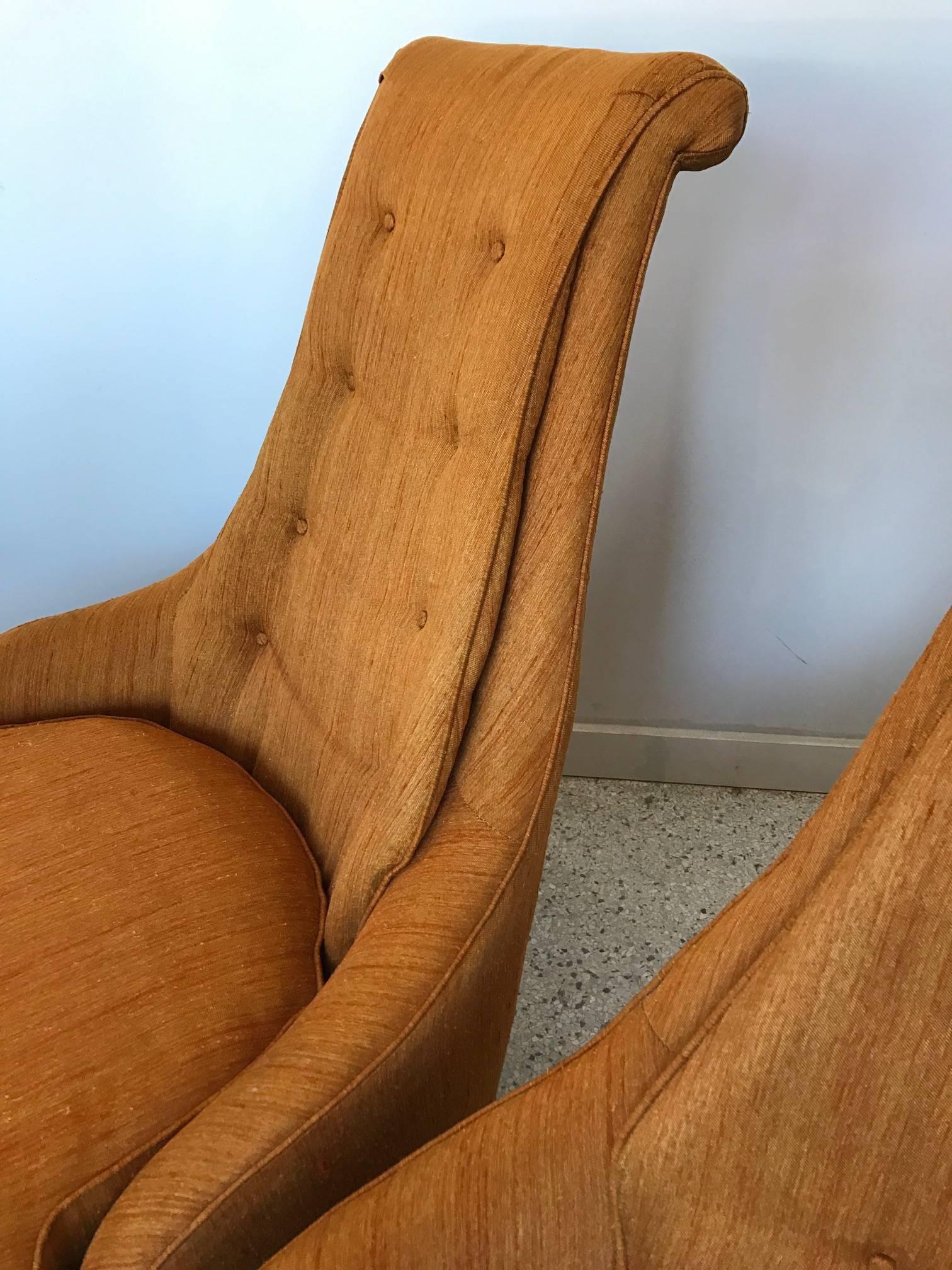 A pair of unusual high back, upholstered slipper chairs by Karpen of California. Original fabric and labels. These chairs are very comfortable and elegant. On chunky, tapered wood legs. Seat height is approx. 16.5