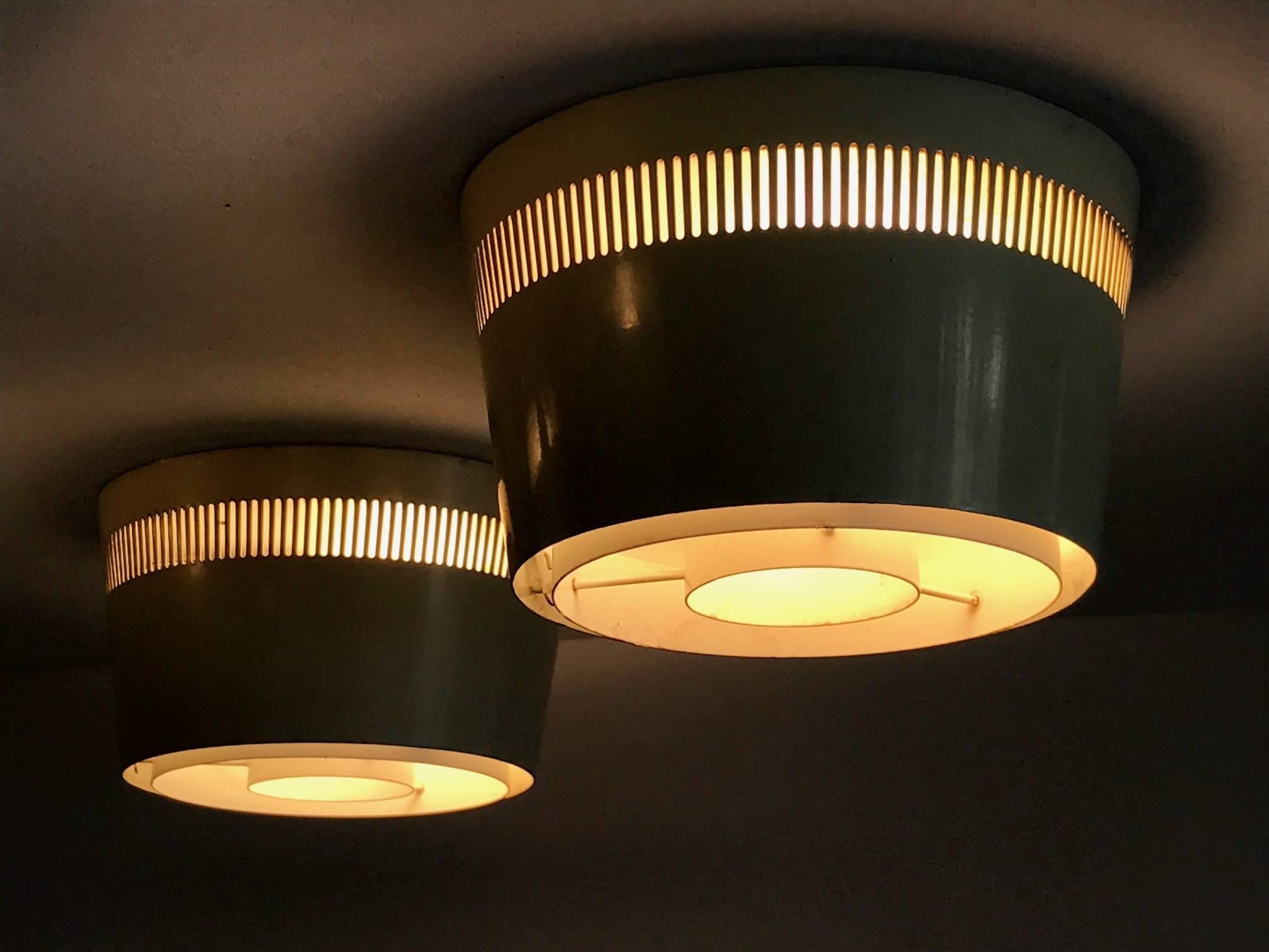 A set of interesting ceiling lights by Itsu, Finland, circa 1950s. Perforated metal, original paint, could be used as sconces or ceiling lights and arranged in any pattern.