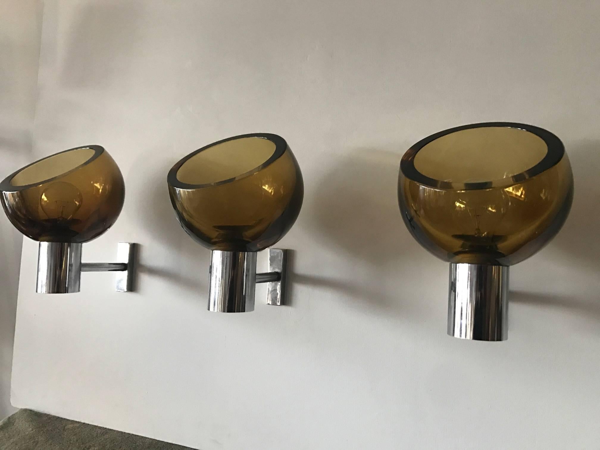 A set of three (3) sconces by Seguso, amber colored glass with chromed hardware.