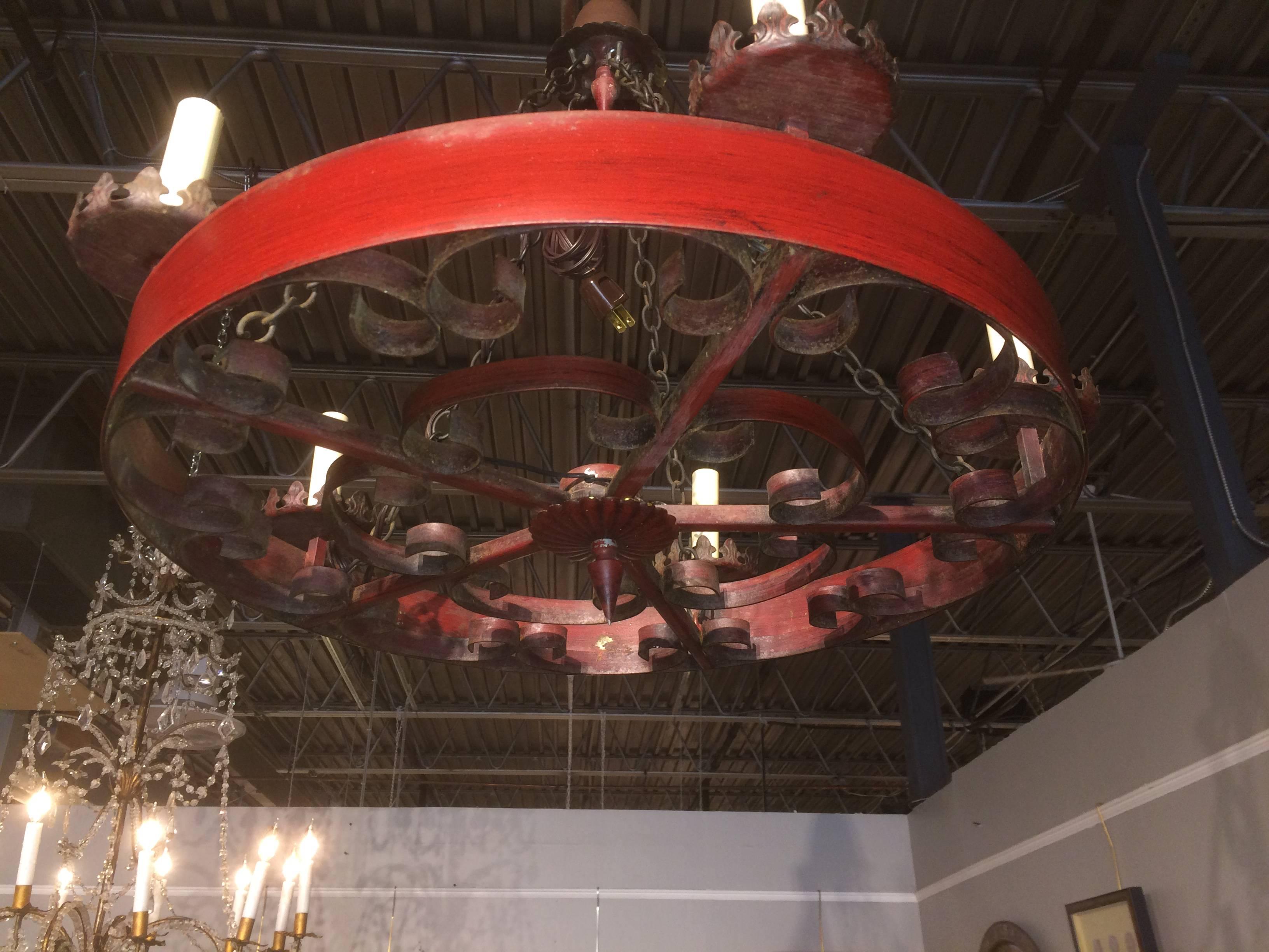 A Spanish Baroque style red tole five-light chandelier.