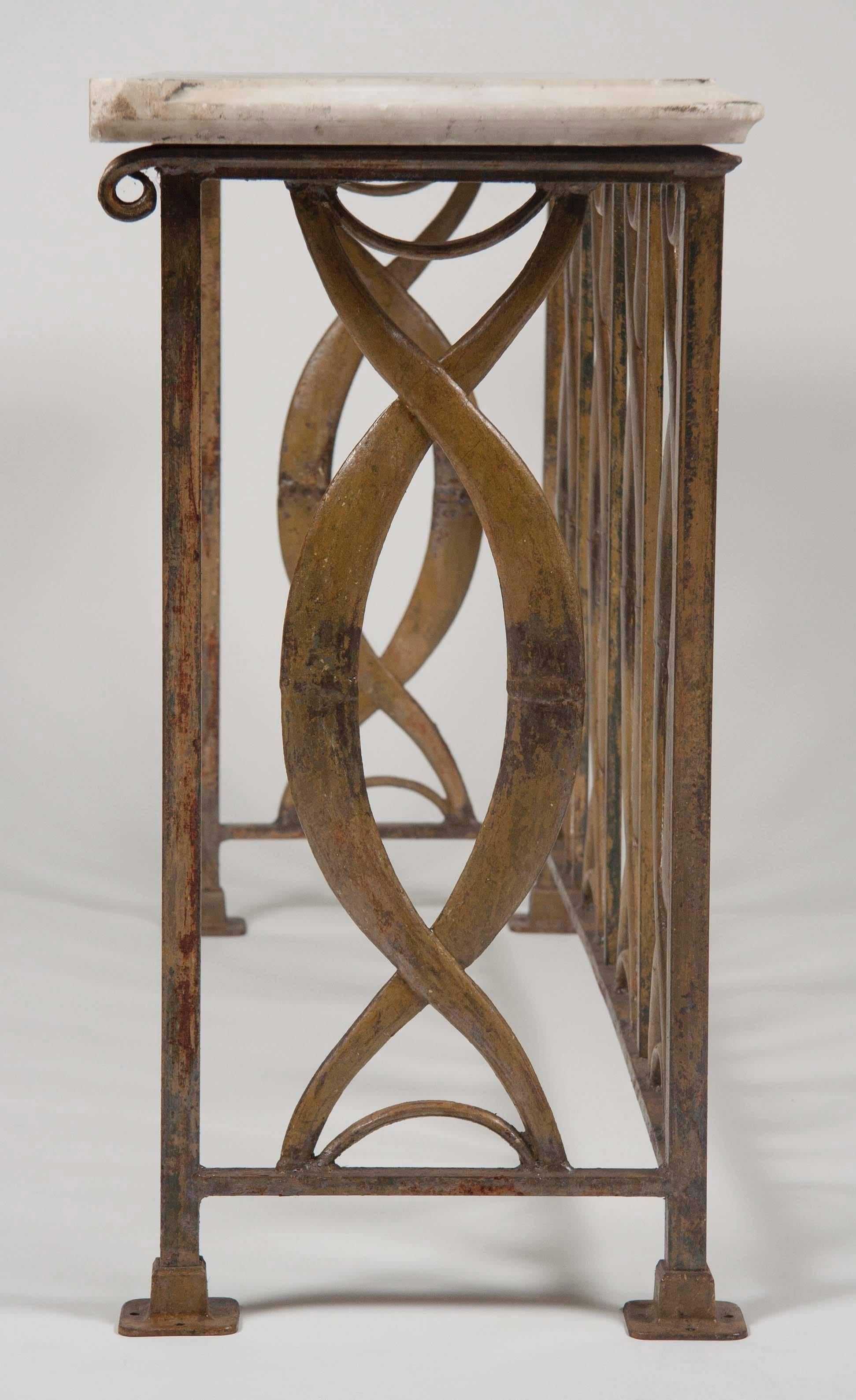An American modern wrought iron piece signed by Chicago maker Julius Blum. Originally an architectural element, now with an associated marble top.