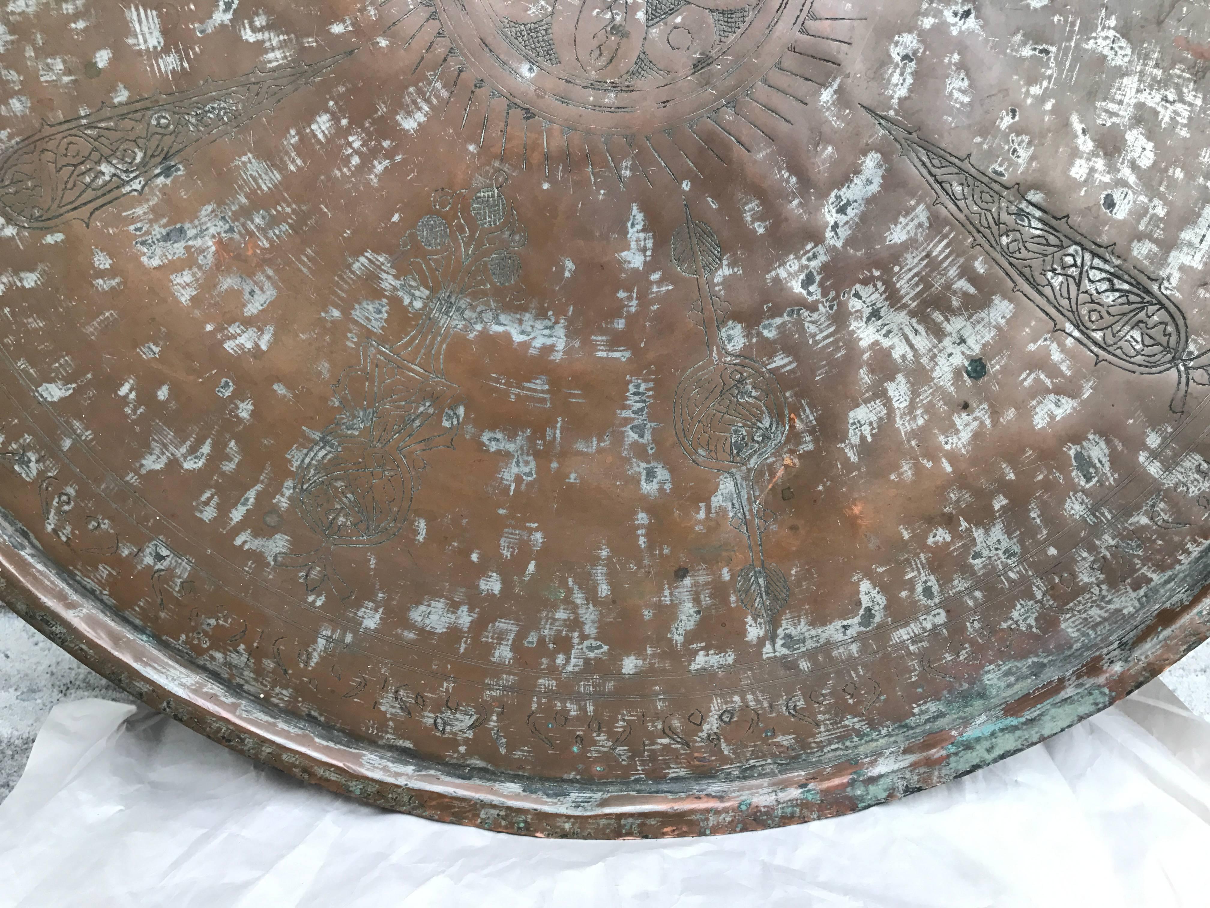 Large-scale antique Moroccan copper charger or tray with traces of silvering. Incised with Moorish inspired decorations. This one has some real age, possibly 18th century. Great surface patina.
