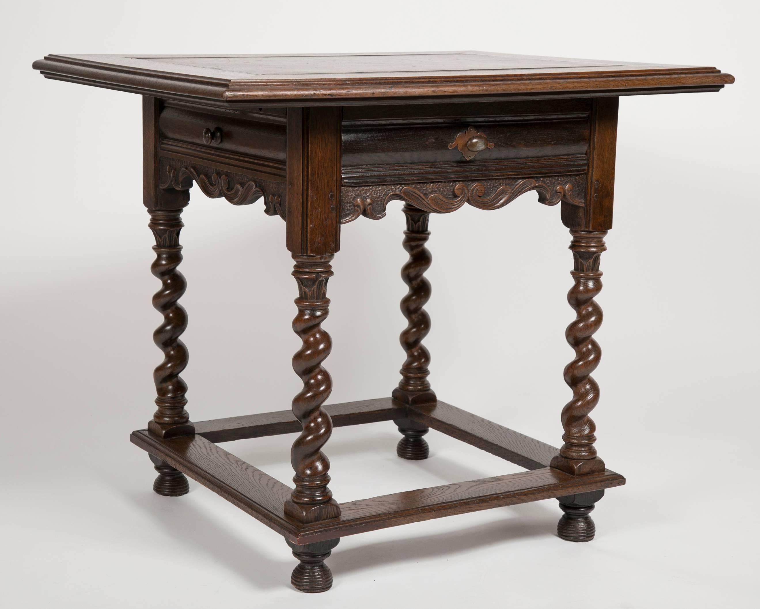 A very handsome Dutch oak center or side table with unusual inlaid slate top. In the Baroque style with barley twist legs and beehive feet. A single drawer with two 'false' drawers on the sides. 
34.5 inches wide 28 deep 29.5 high