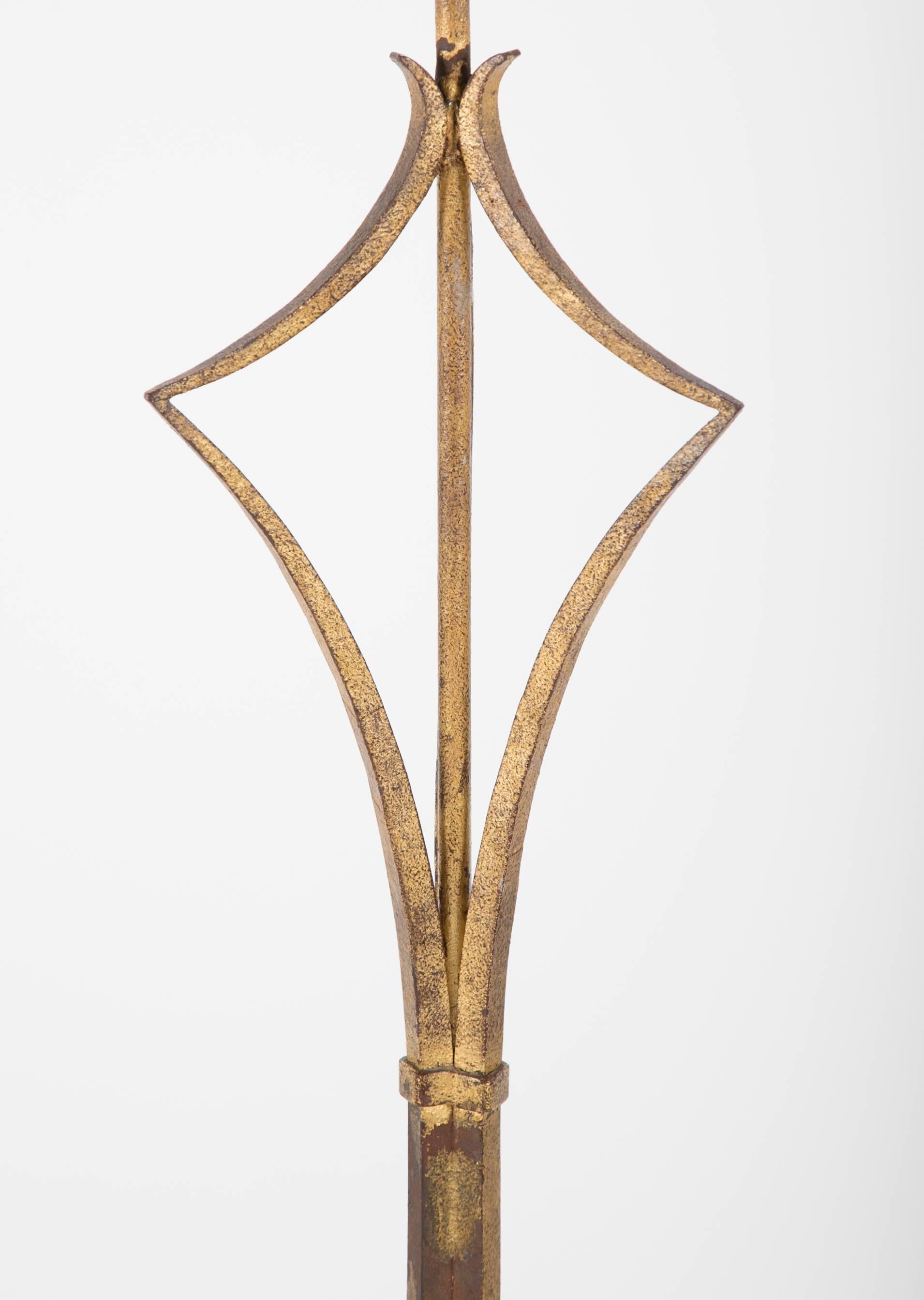 Elegant French gilt wrought iron, the tripod base with ball feet supporting. Beautiful and sophisticated construction of three bound iron rods that open to a delicate triangle at the top.