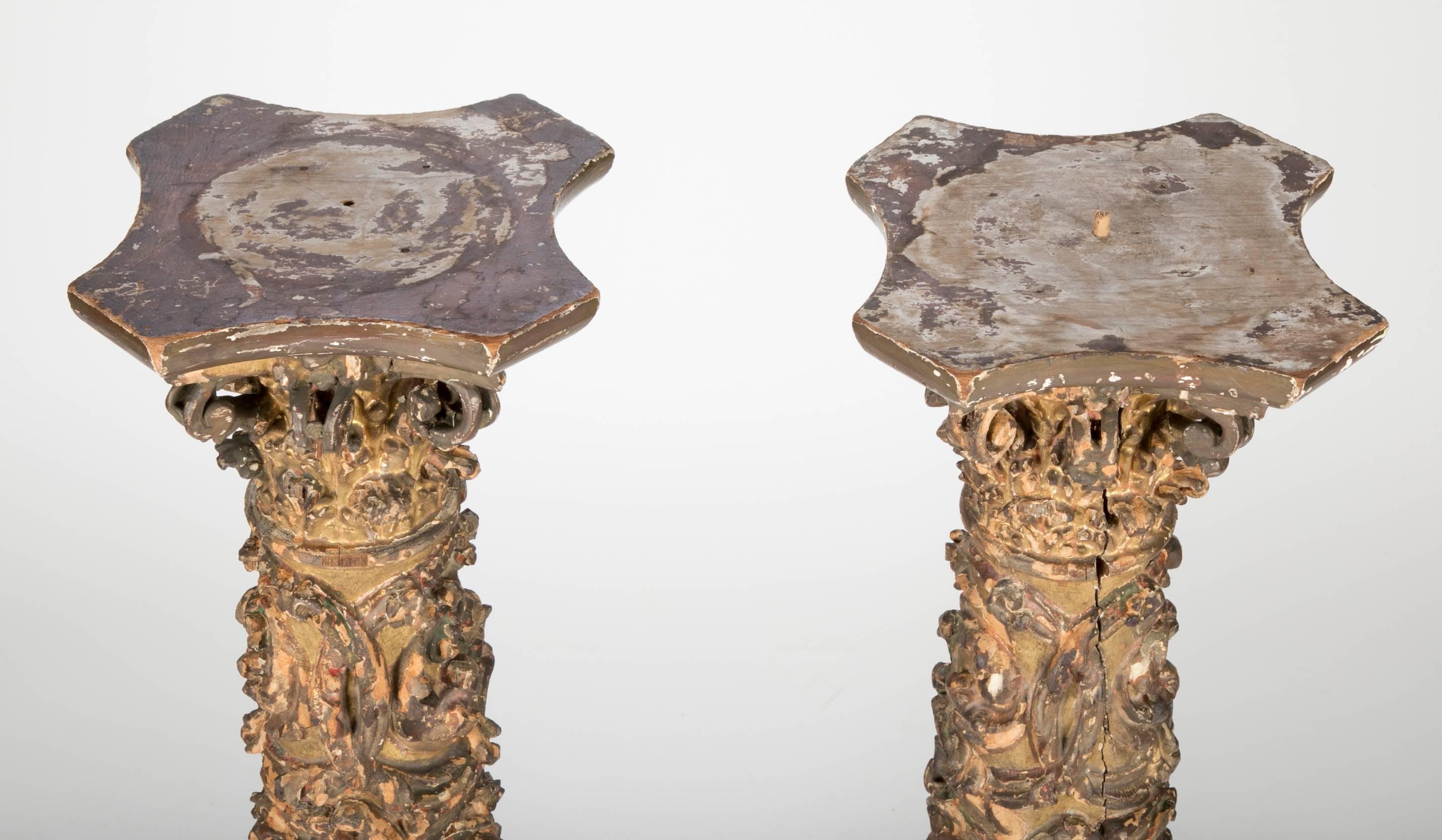 Wonderful pair of Spanish 17th century giltwood columns with exceptional carving decorated in the estofado technique of polychrome over gilding with a scratched out design. With birds, putto heads acanthus and other floral decoration. The backs are