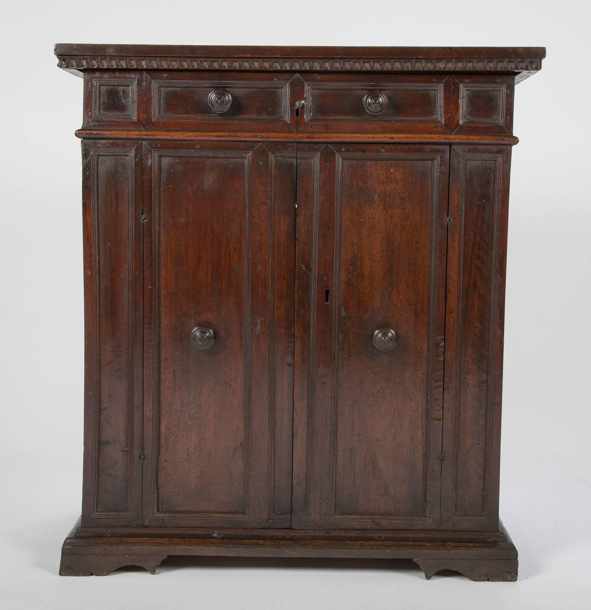 Italian 16th-17th century walnut credenza with unusual lift top with false drawer front. Retaining the original key that works both locks, and the original cotter-pin hinges. Classical form, warm and rich patina. A purists dream.