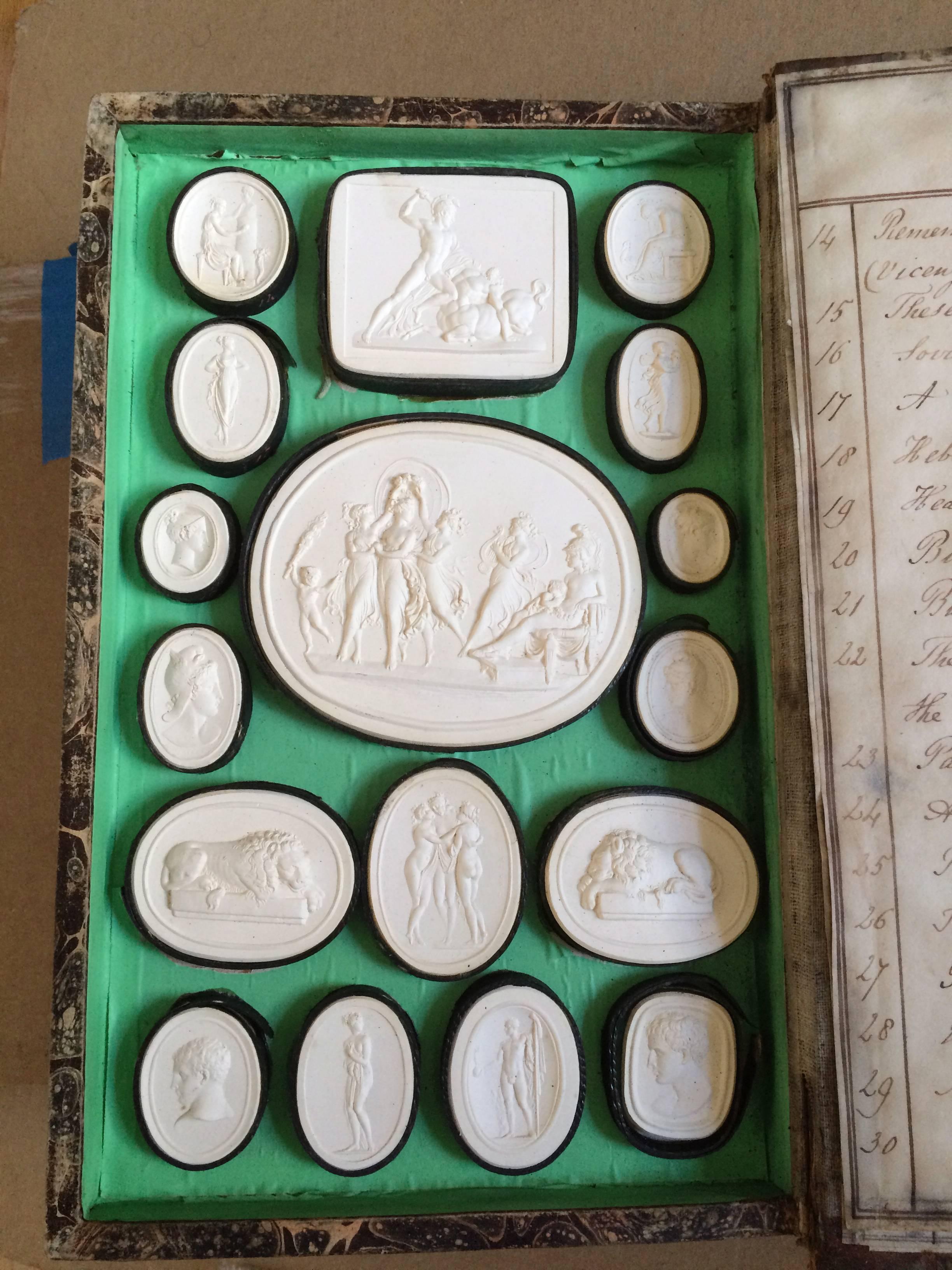 Superb set of Italian Grand Tour plaster intaglios depicting famous art works of Antonio Canova, 1757 – 1822 in Fine detail. Collected in the original book created by the maker Paoletti. The book with marbled paper boards and vellum spine, with hand
