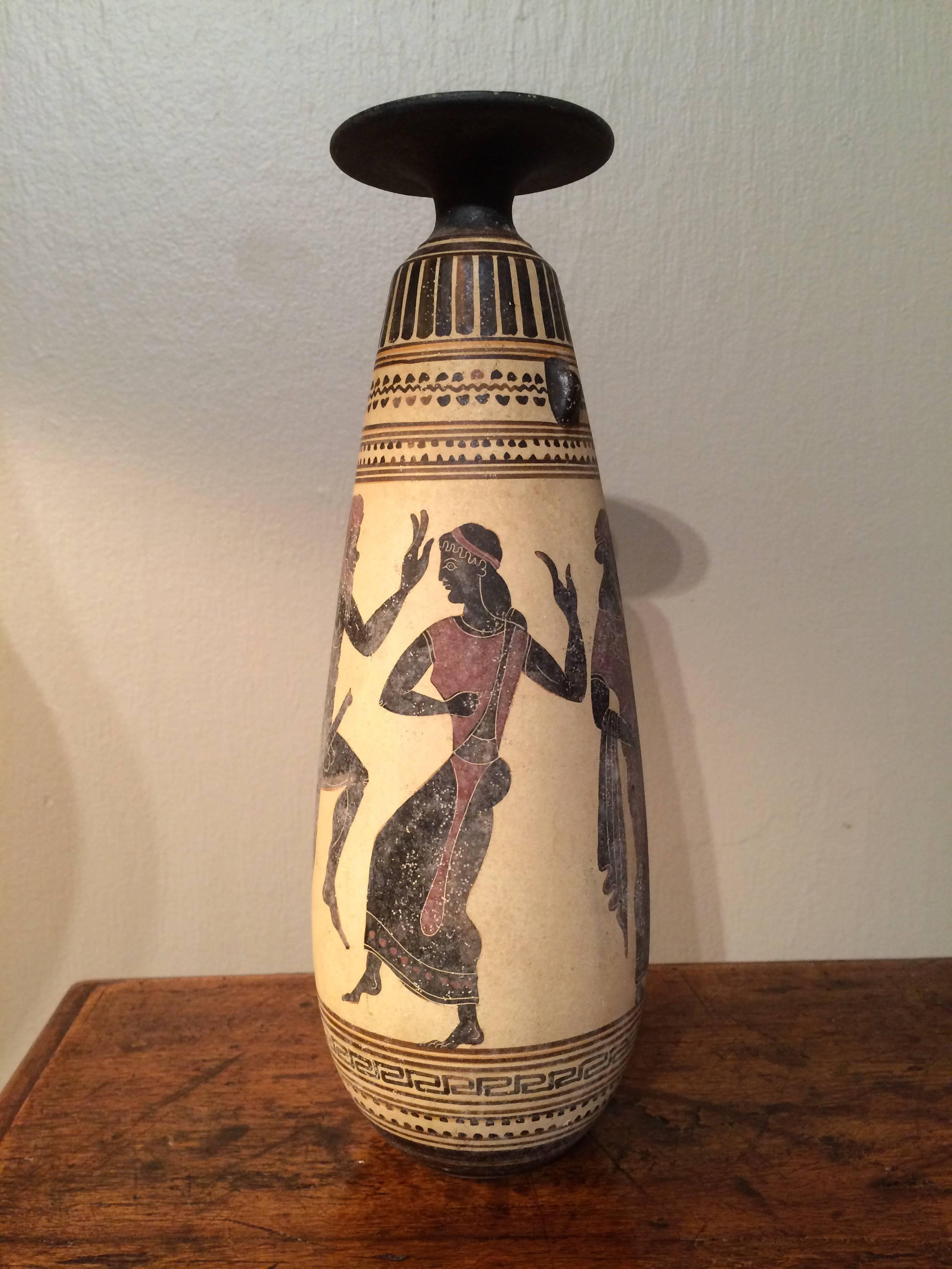 Classical Greek pottery vase showing a randy Bacchic faun chasing a Maenad.  In the form of an alabastron, a small type of pottery or glass vessel used in the ancient world for holding oil, especially perfume or massage oils. A copy after an ancient