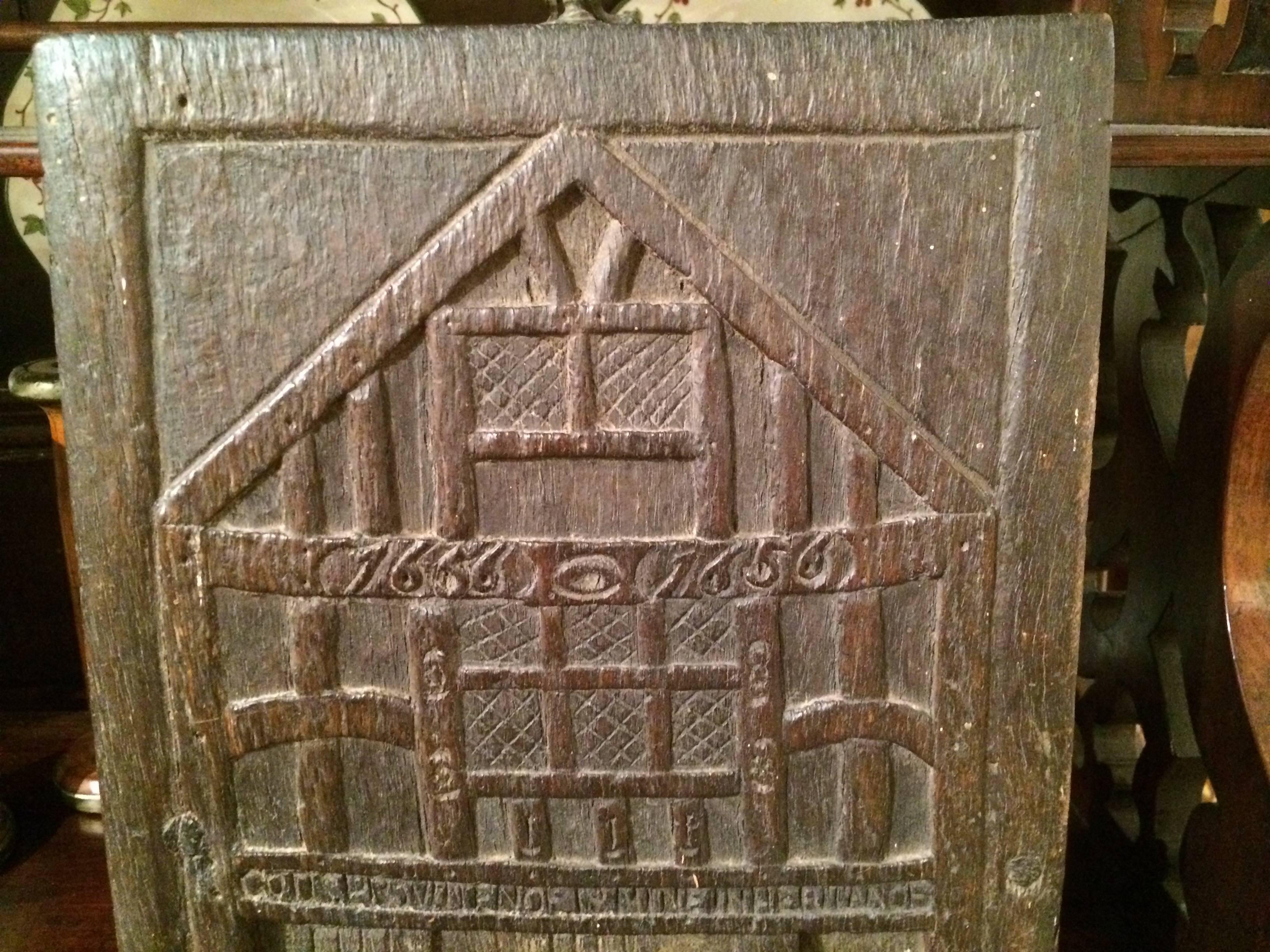 Chestnut panel carved in relief showing a model of 'God's Providence House' in Chester, England. 
Dated on the reverse in Roman numerals 1710.

The original building on the site was constructed in the 13th century but the present house was built