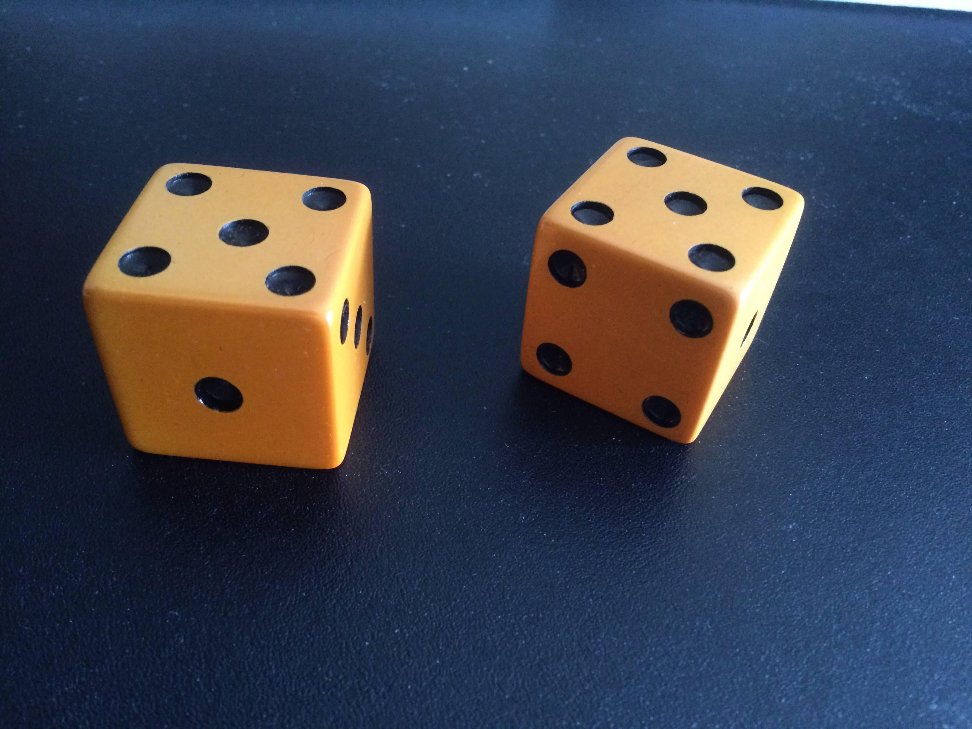 Very cool pair of large-scale dice made of butterscotch bakelite, wonderful color and patina, American, 1920s.
