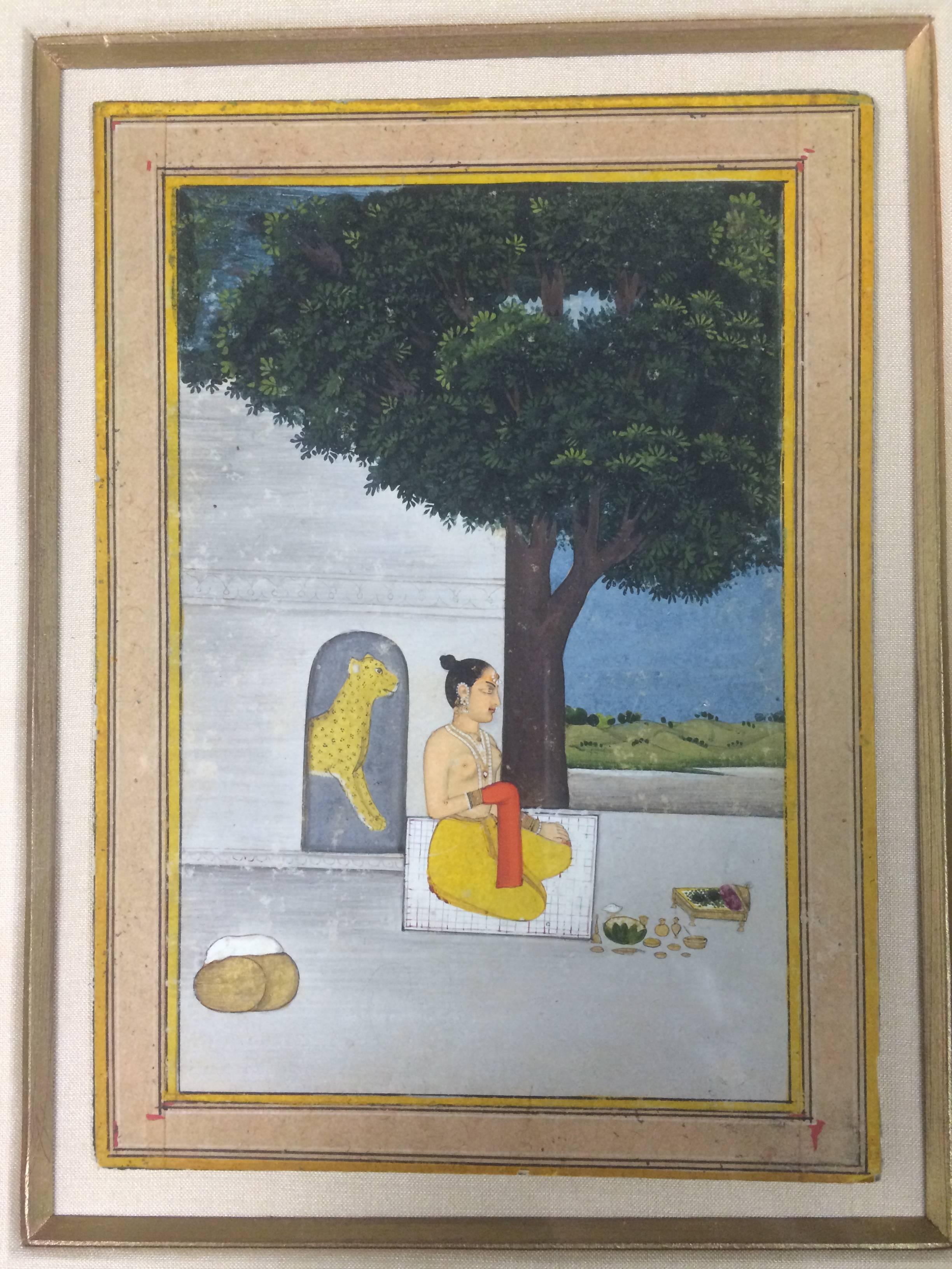 An illustration to a Ragamala series
Deccan, Central India, late 18th to early 19th century
Opaque pigments heightened on paper, the lone lady depicted topless, kneeling and making an offering, a yellow panther behind.