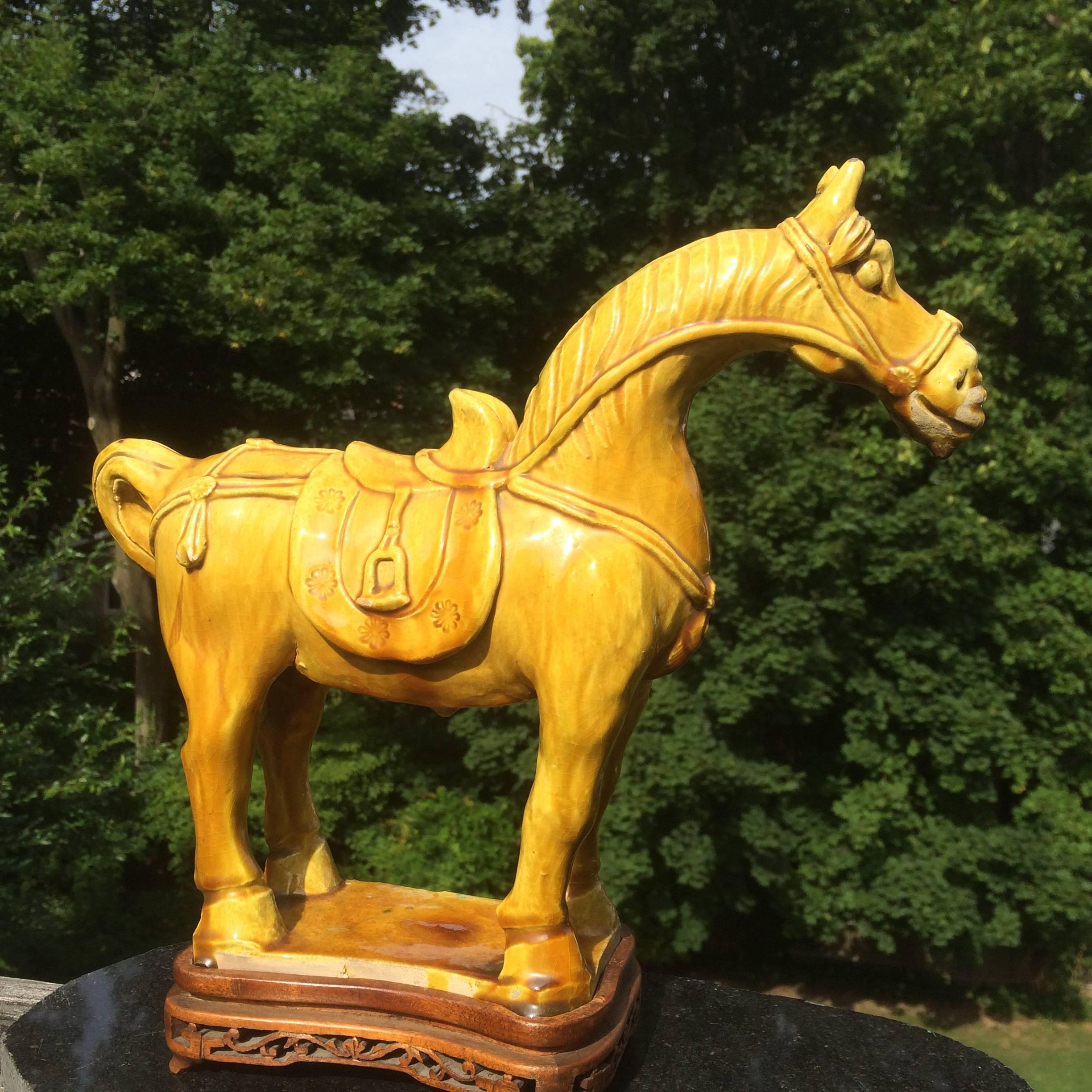 Chinese terracotta figure of a caparisoned horse with a beautiful golden yellow glaze. On custom-made antique base.

10.5 inches high without stand 11.5 with stand.