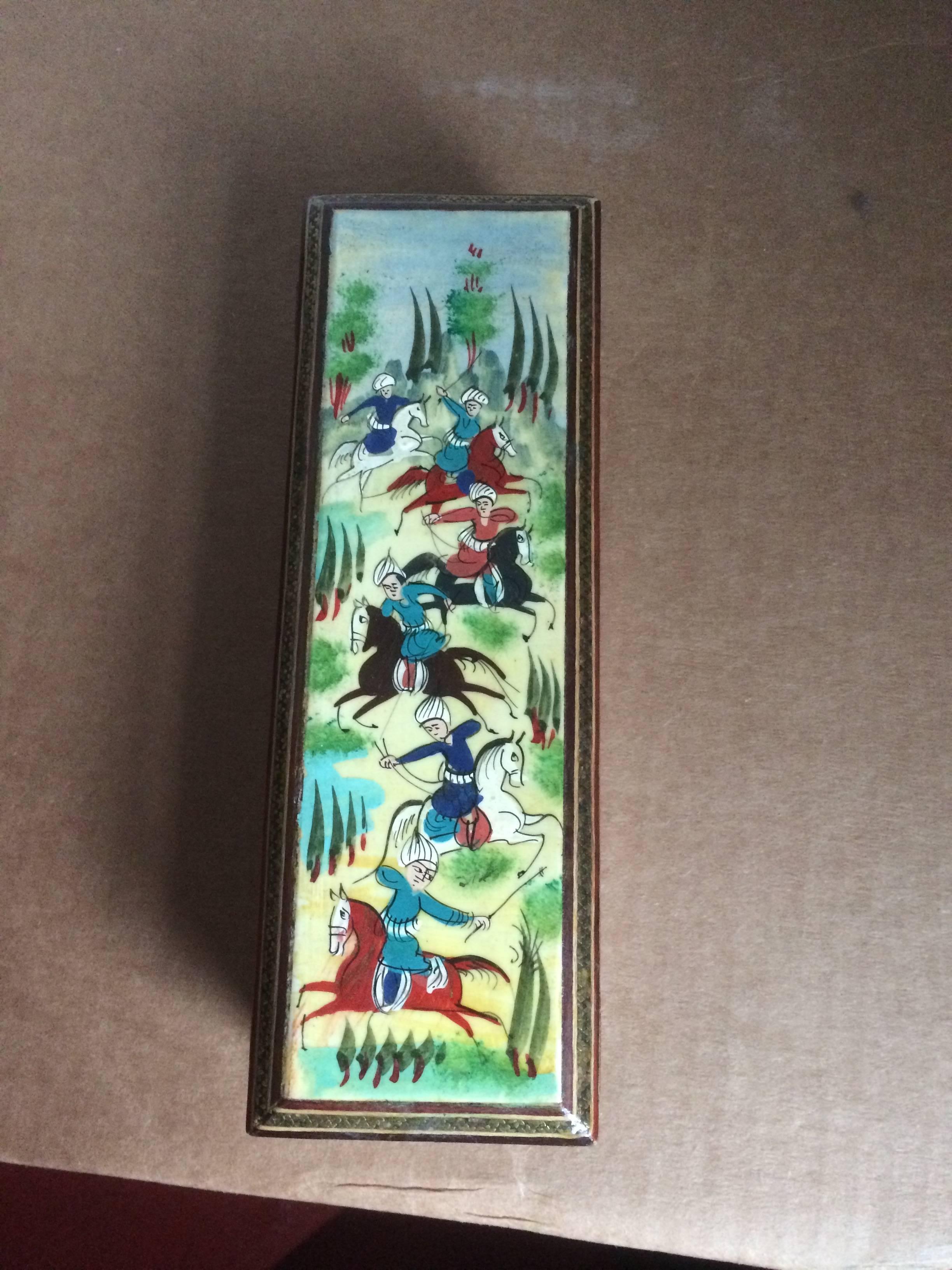 Intricately inlaid Persian pen box, the top painted with a vibrant scene of polo players in action. The entire box, interior, exterior and even the bottom with beautiful geometric inlay of brass, polished bone and colored woods.