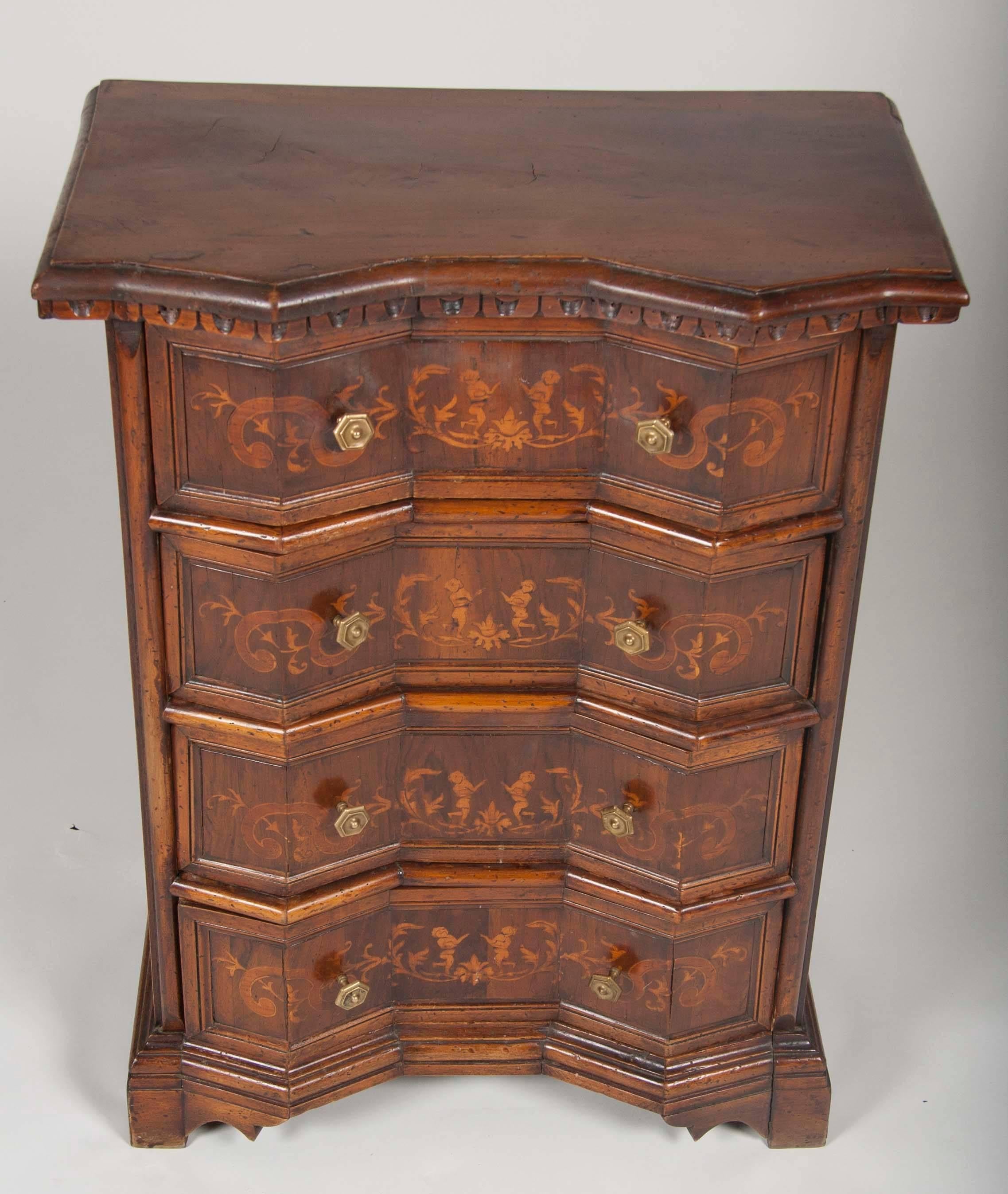 Italian Baroque style walnut 'comodino,' or chest of drawers, with fruit wood inlay and bronze hardware. Done in the Tuscan style with an appealing shaped geometric front. Great as a bedside cabinet.