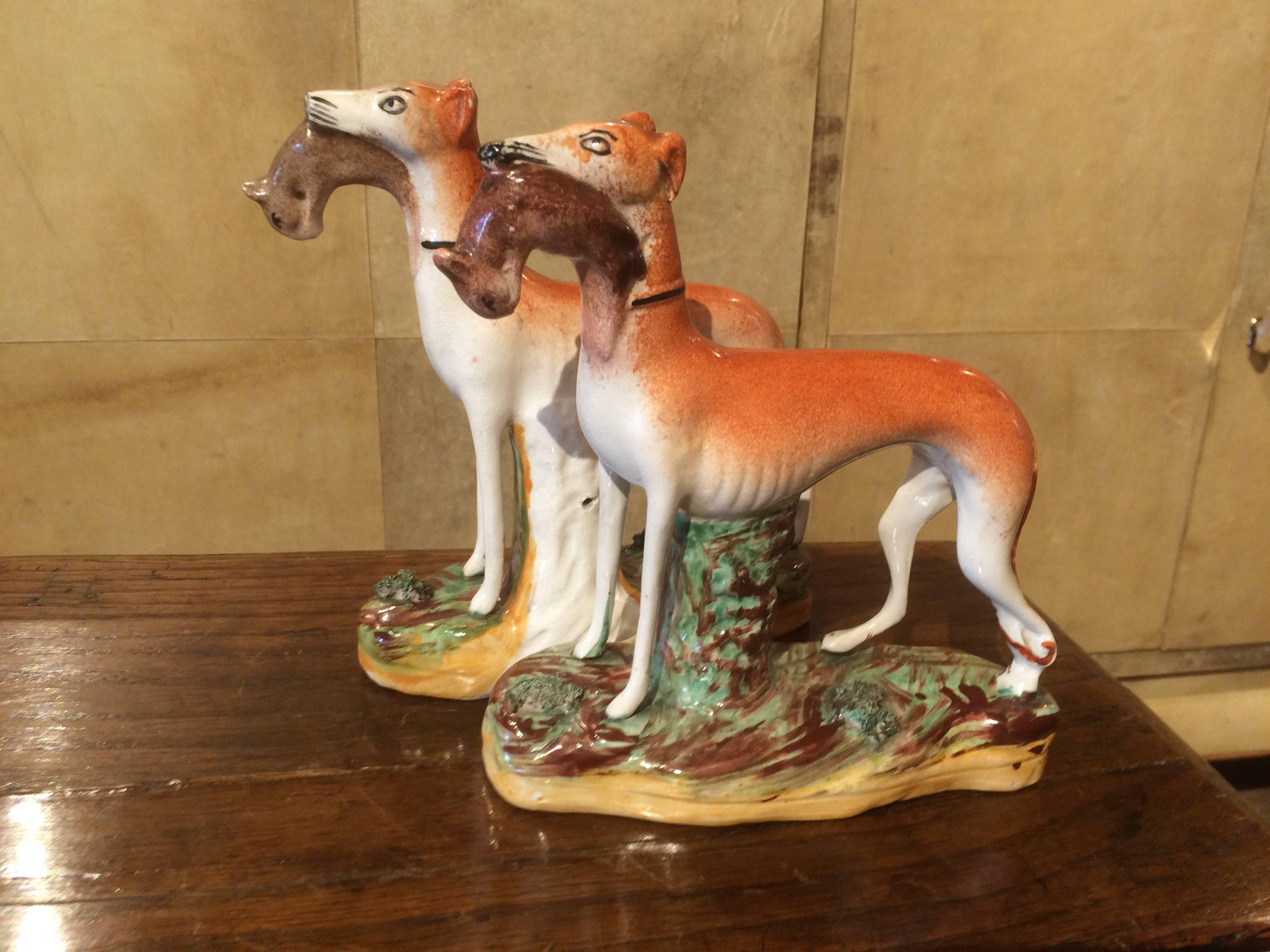 Porcelain Pair of Straffordshire Greyhounds or Whippets with Rabbits