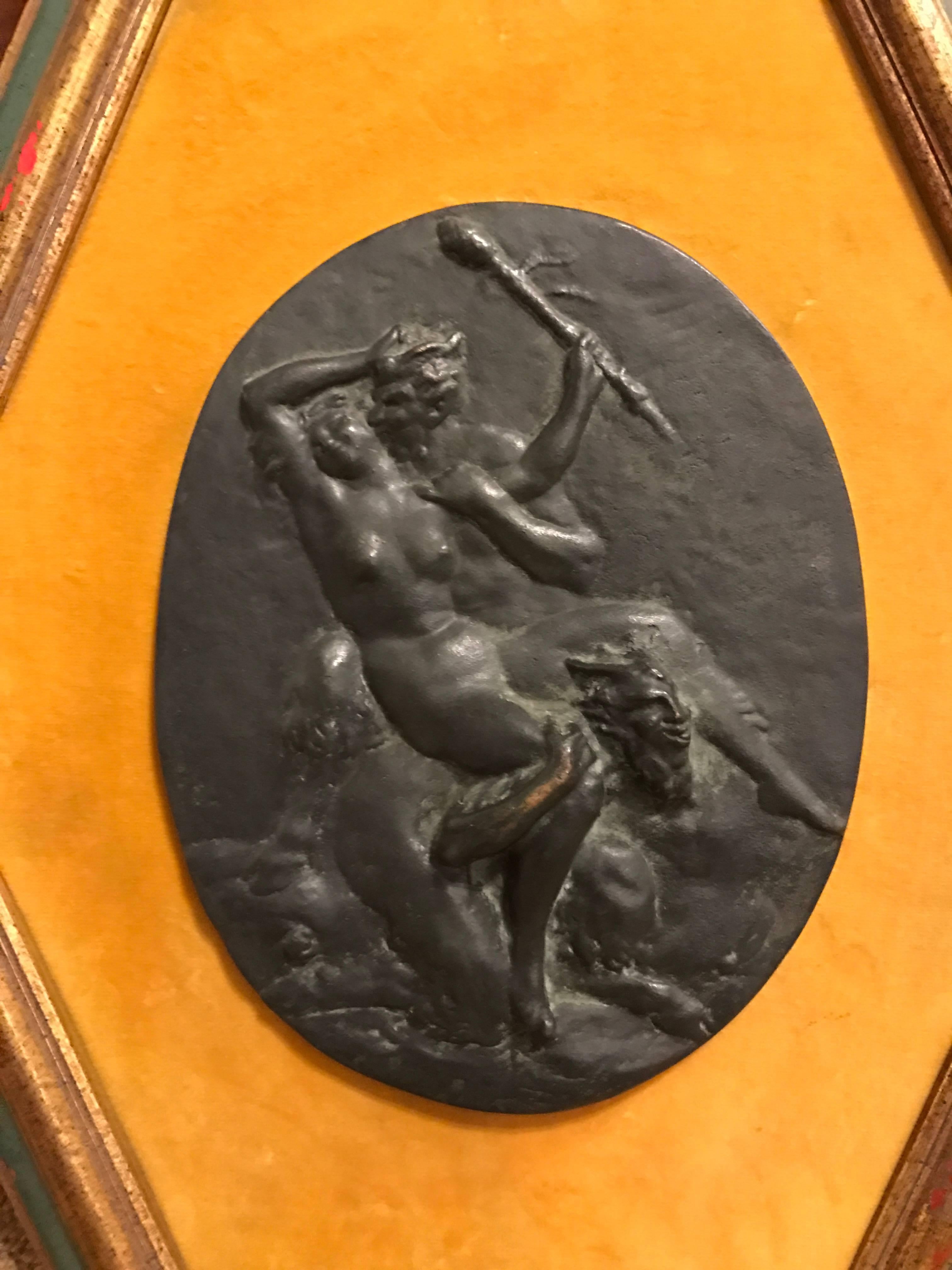 Late 18th-early 19th century Austrian oval bronze plaque depicting a nymph cavorting with two satyrs. In the style of Georg Raphael Donner. Mounted on velvet set in a hexagonal frame.

Measures: Just the oval 9.5 by 7.25 inches.