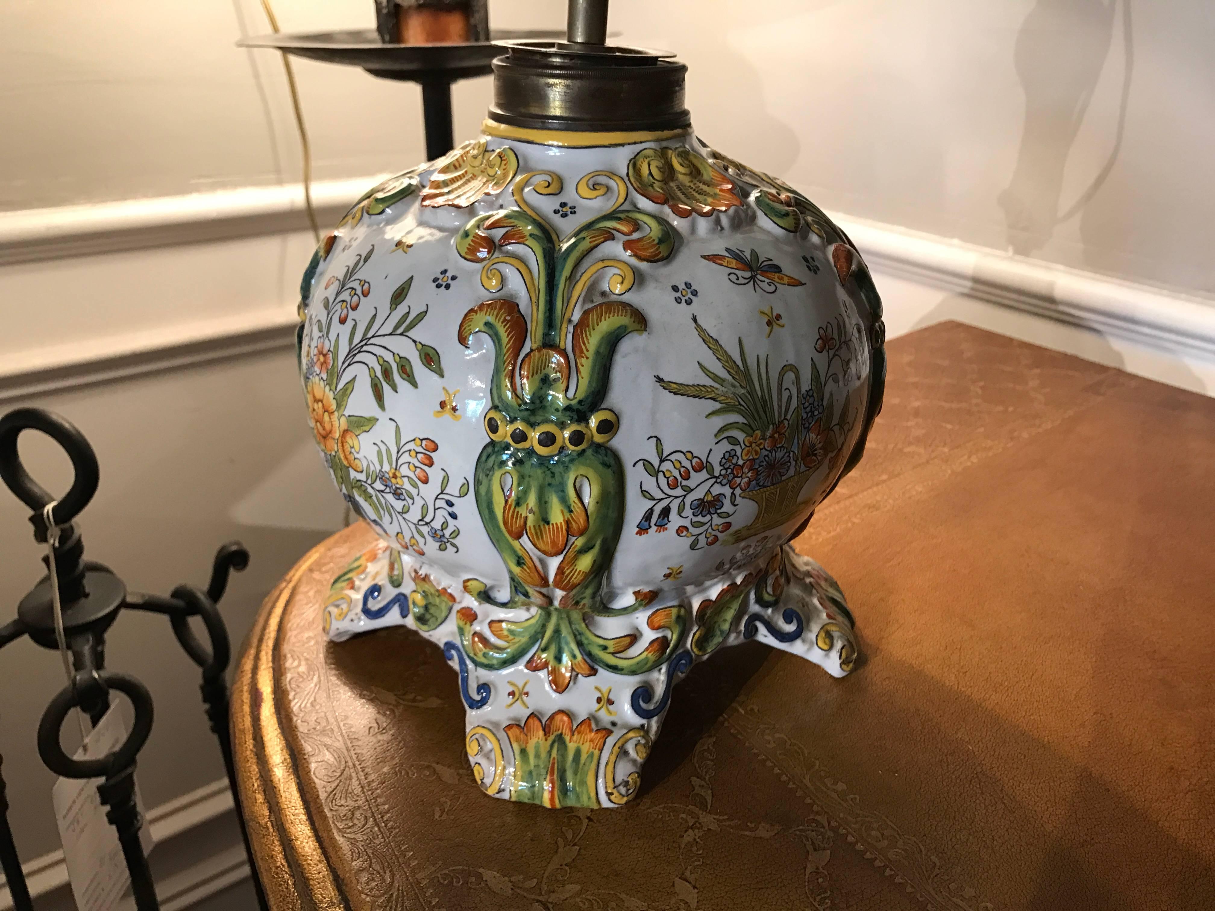 French glazed ceramic oil lamp now wired for electricity decorated in the bright colors typical of the Rouen style, with flower baskets and bouquets. Signed with the monogram FF, the signature for Fourmaintraux Freres. 

From the famous