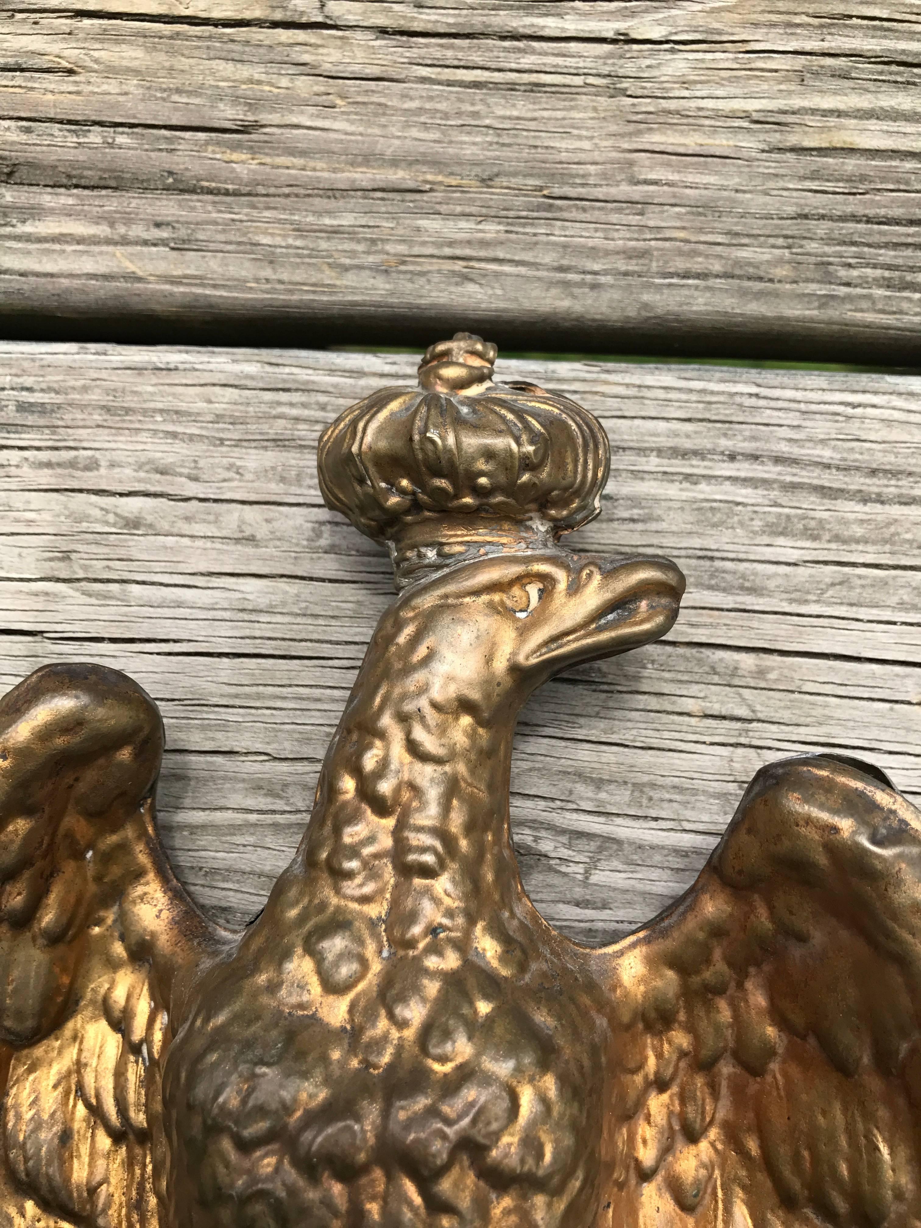 French Napoleon III gilt brass finial for a banner or flag standard. The crowned eagle shown with wings spread. On a later wood base enabling it to stand on it's own as a piece of sculpture.