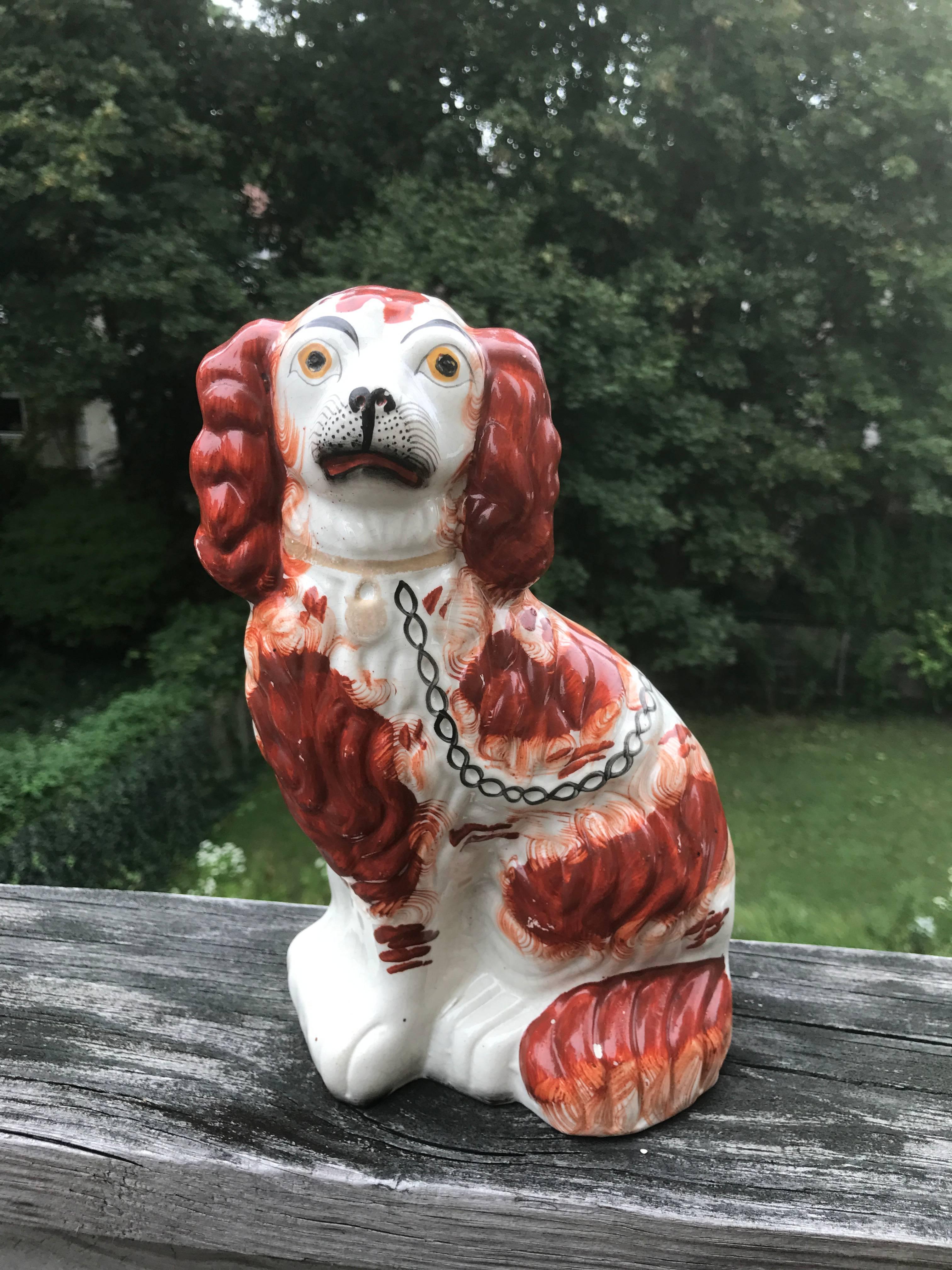 Fine pair of English Victorian Staffordshire porcelain spaniels with the nonplussed expression that makes these figures of dogs so irresistible.