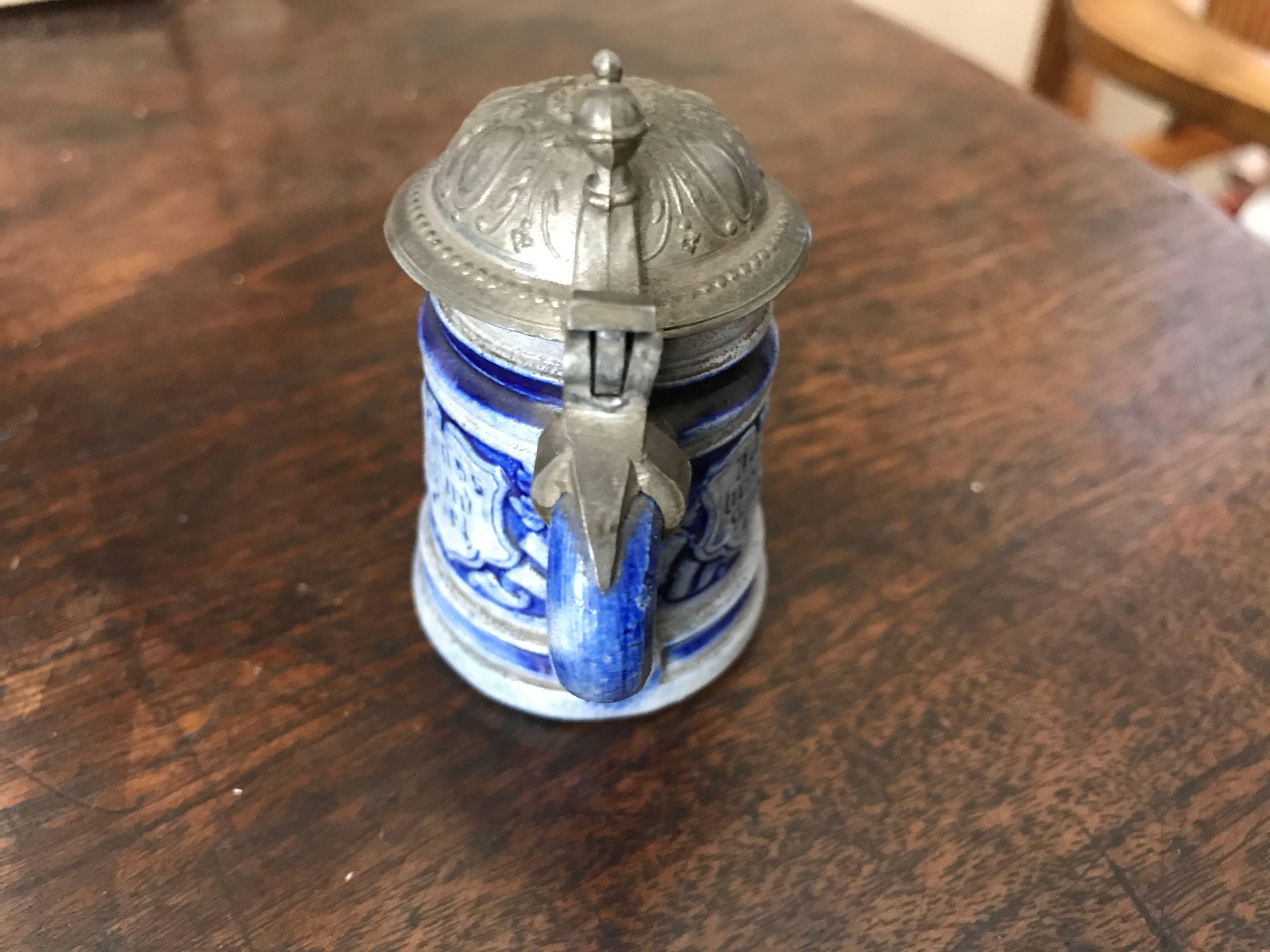 Vintage miniature glazed stonewear German beer stein in the blue and gray 'Westerwald' style. With pewter hinged lid. The German saying 