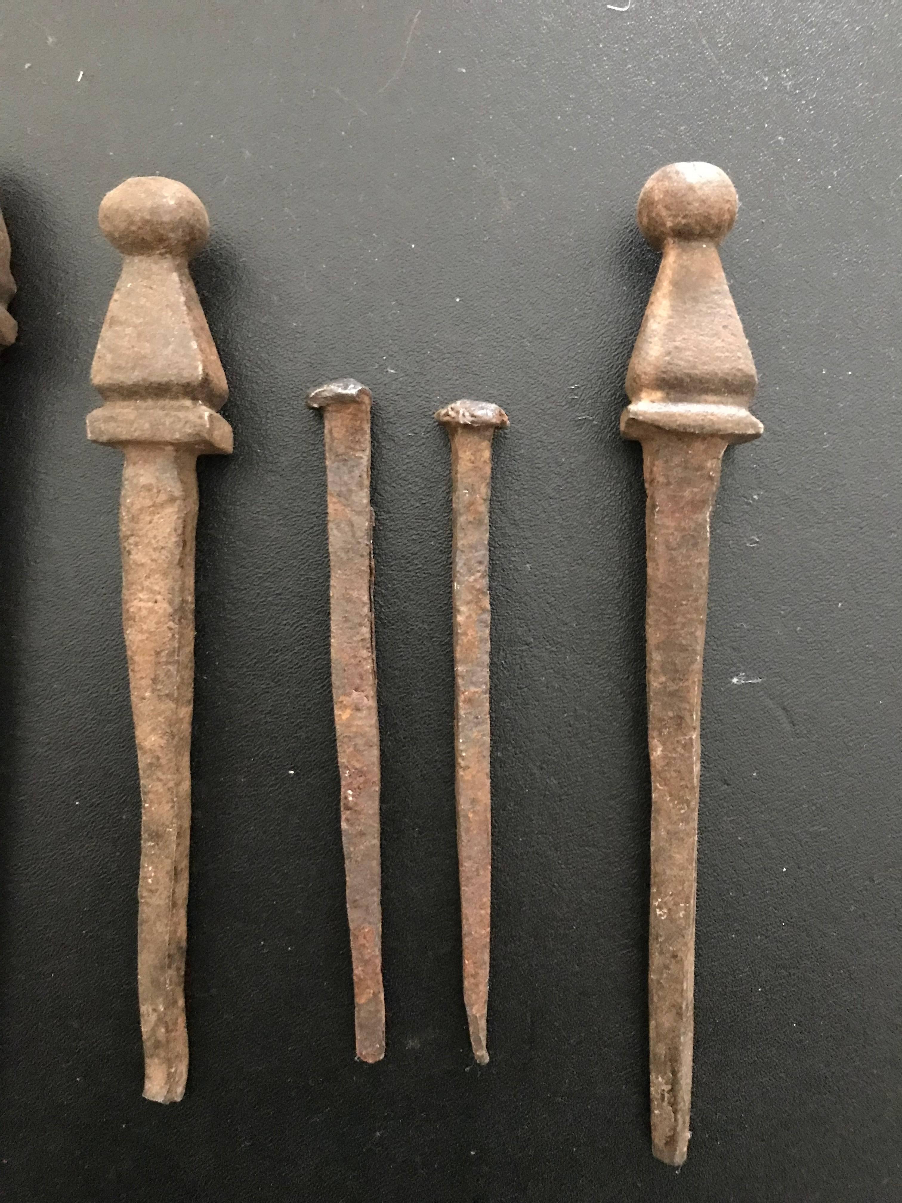 Amazing group of eight rare 16th/17th century (possibly earlier) Spanish or Italian wrought iron nails. These hand wrought nails show incredible workmanship. Each a miniature sculpture. These would have been used to hold together an early chest or