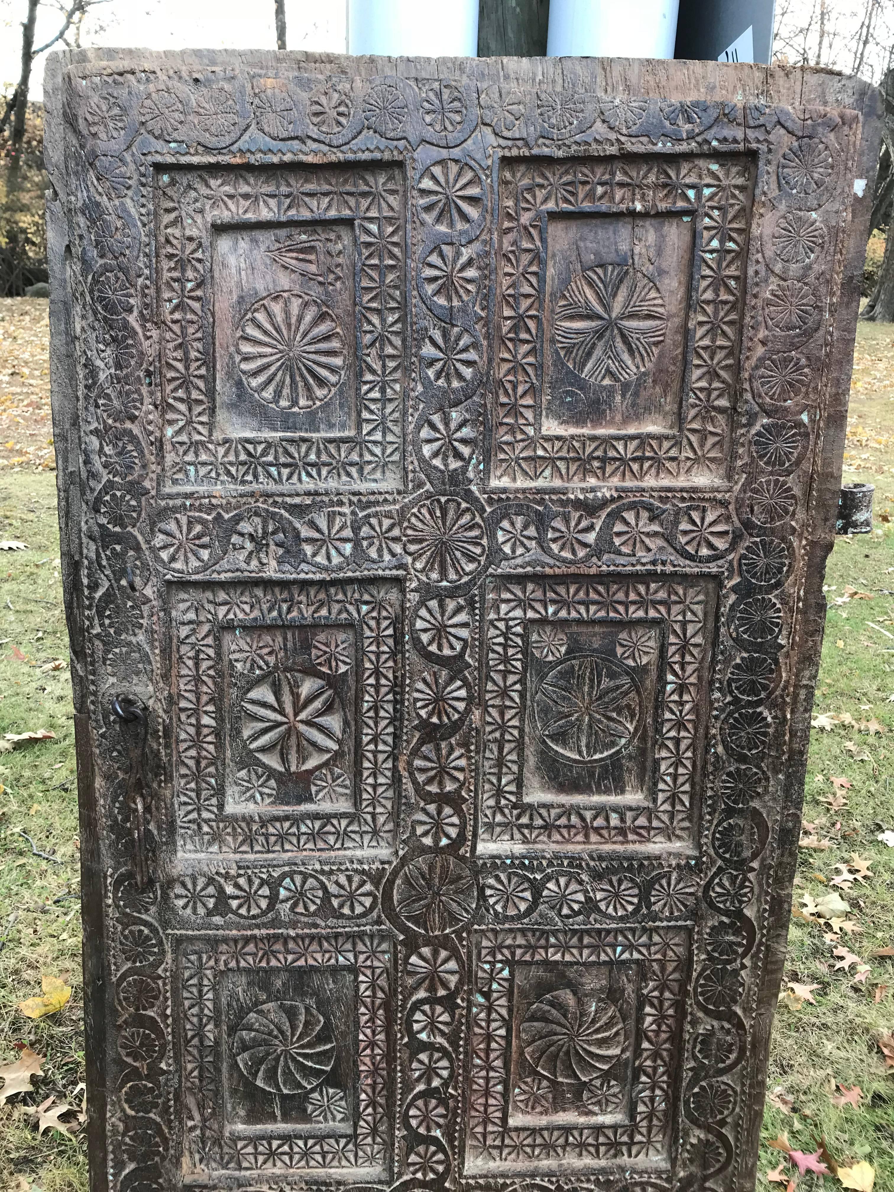 Impressive and finely carved shutter or door with a compelling geometric design. Some traces of blue paint. With wrought iron hinge and hasp, the reverse not carved. More photos coming soon. Can be mounted or hung on a wall. Five feet tall.
60