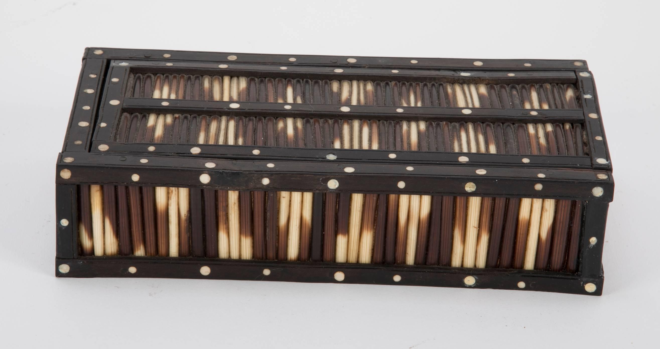 Anglo-Indian box with porcupine quills framed by rosewood with circular bone inlay. A nice geometric pattern in the quills decorating this pen box. Made in colonial Ceylon, present day Sri Lanka. 

Part of a group of seven quill items we recently