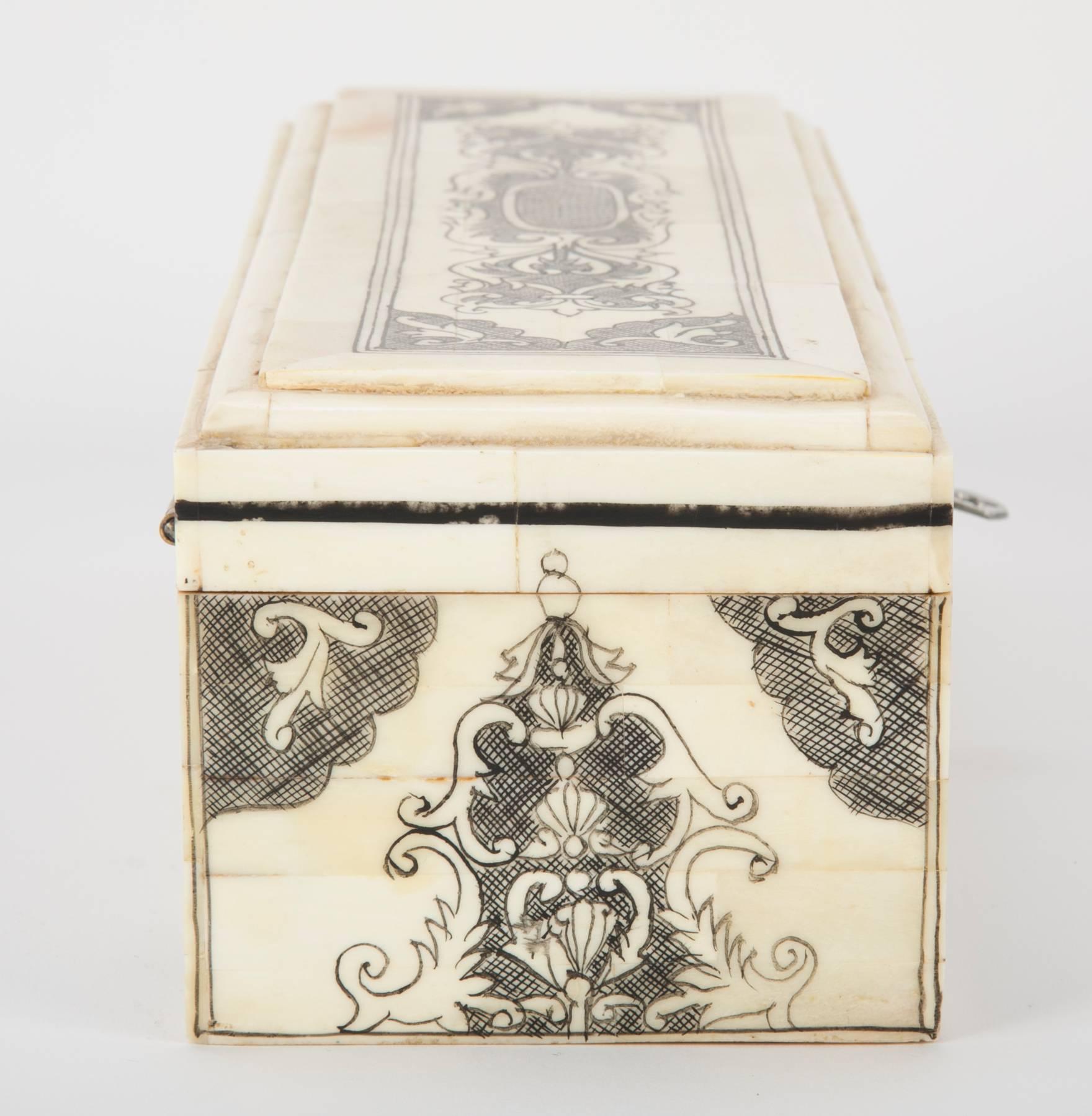 Anglo-Indian style pen box with camel bone veneer decorated in etched and inked designs. With key and single drawer on one side.