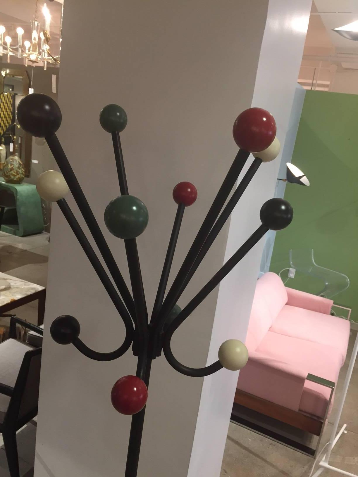 Distinctive French Design from the 1950s. Metal base and each arm capped with a wood ball. 
Four different color balls: Red, black, white and green.