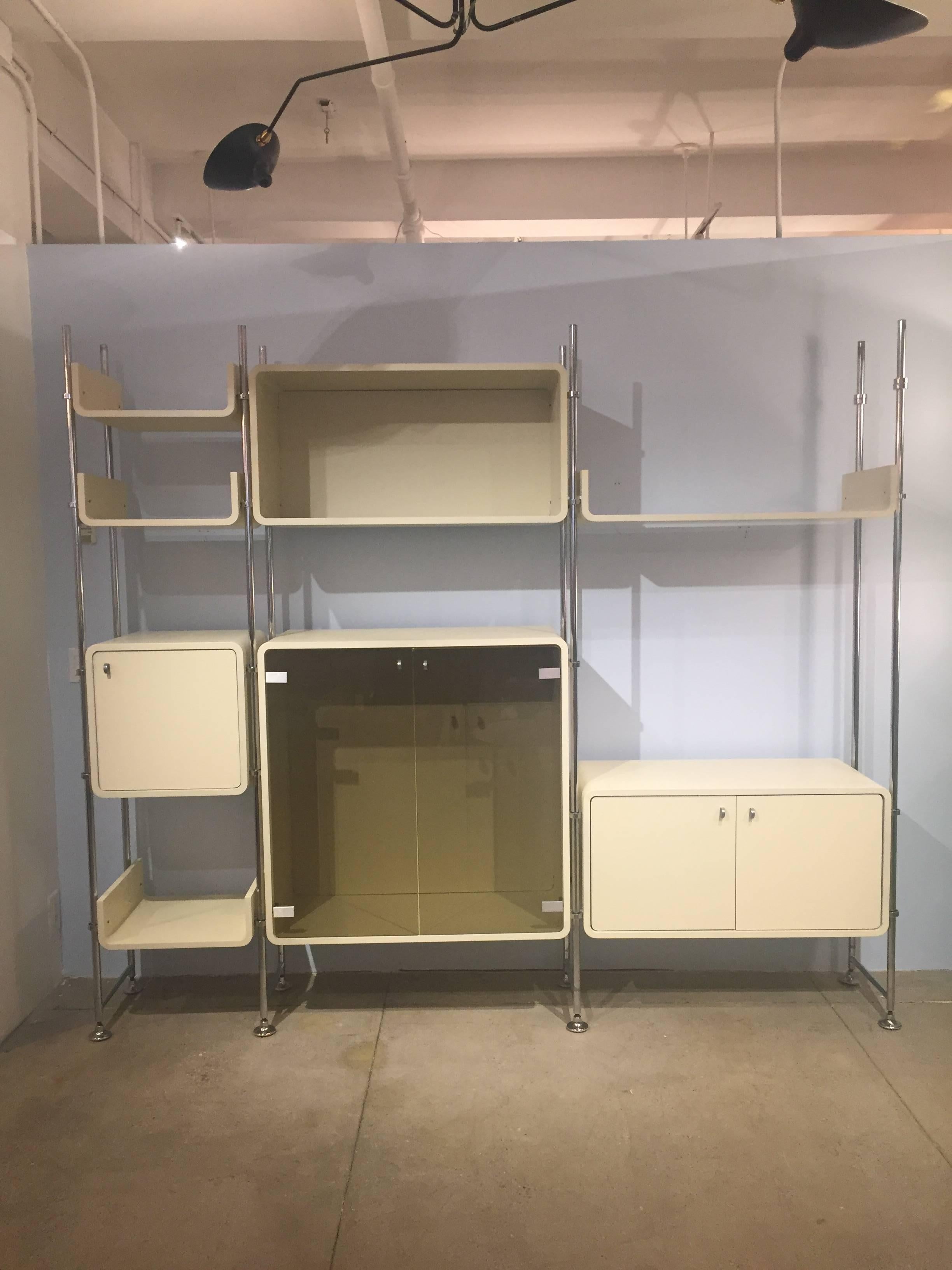 This stylish shelving unit utilizes a simple yet clever adjustable system for hanging the various shelves and cabinets that is highly adjustable, visually appealing, and also very stabile.