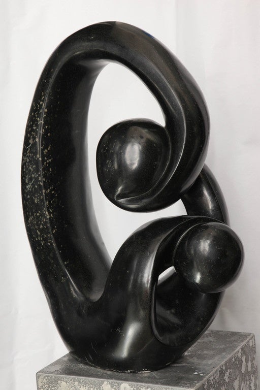 A Shona African modernist sculpture, produced circa 1990s, masterfully hand-carved from marble. Markings include artist's signature [Edmore Makotore] to the bottom of the sculpture.