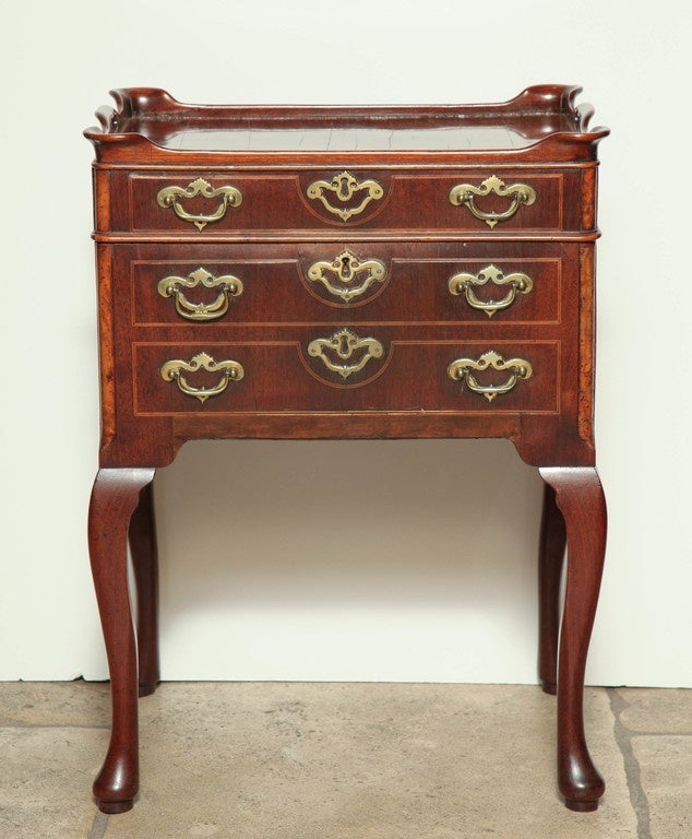 A Dutch Queen Anne walnut side cabinet with a galleried lift-lid, and fitted with a small side drawer; the front mocked as 3 drawers, raised on cabriole legs.