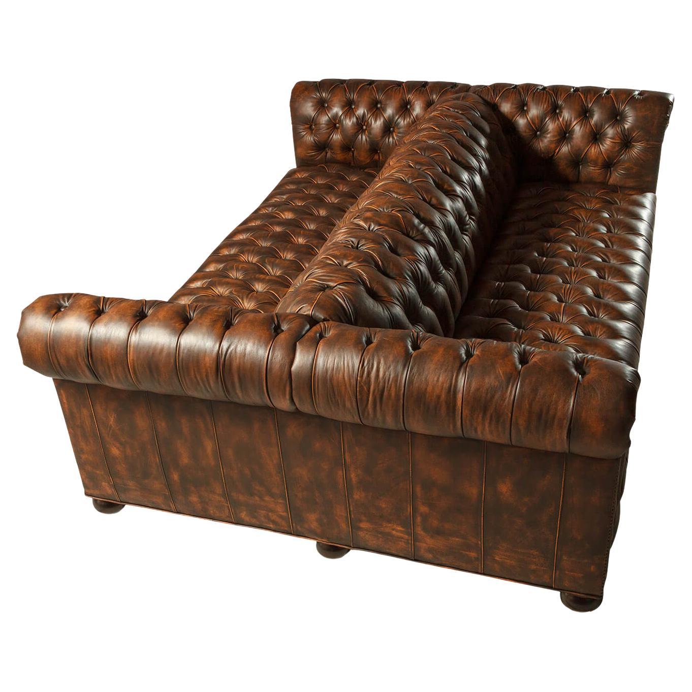 This leather sofa is upholstered in our high-grade Newport Toffee leather. With tightly tufted backrests and seat cushions with high-density foam, with natural finish brass nailhead details raised on bun feet. 

With our uniquely treated