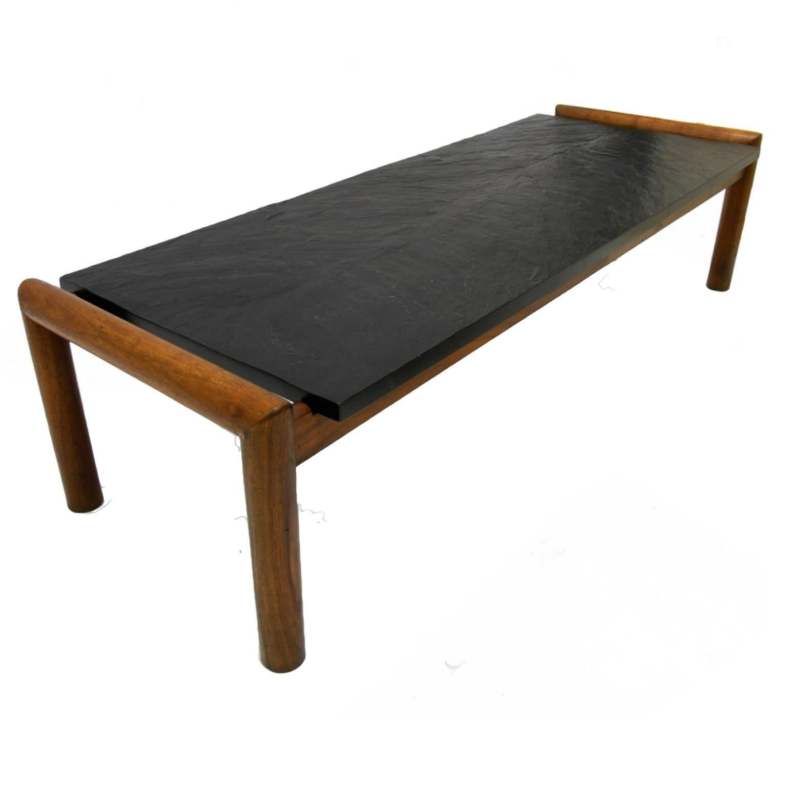Make a statement in your living room with this very handsome Brutalist slate coffee table by designer Adrian Pearsall. The slab of natural slate is one inch thick that sits on a frame made of solid walnut.