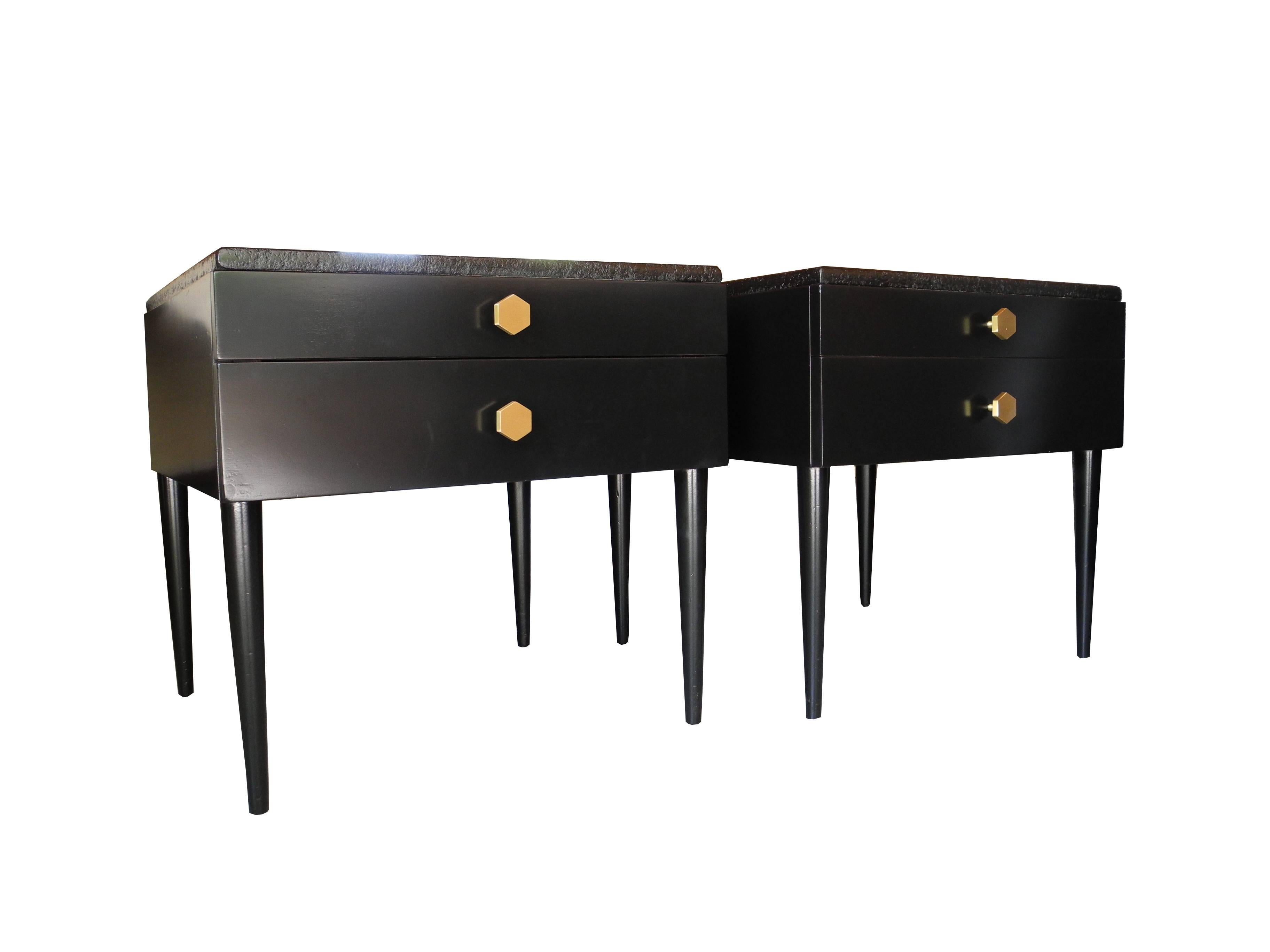 These modern vintage side tables which could be used as bedside tables are equipped with two drawers each that have solid brass hexagon knobs. The beautiful cork tops are unique to Paul Frankl's Mid-Century designs.