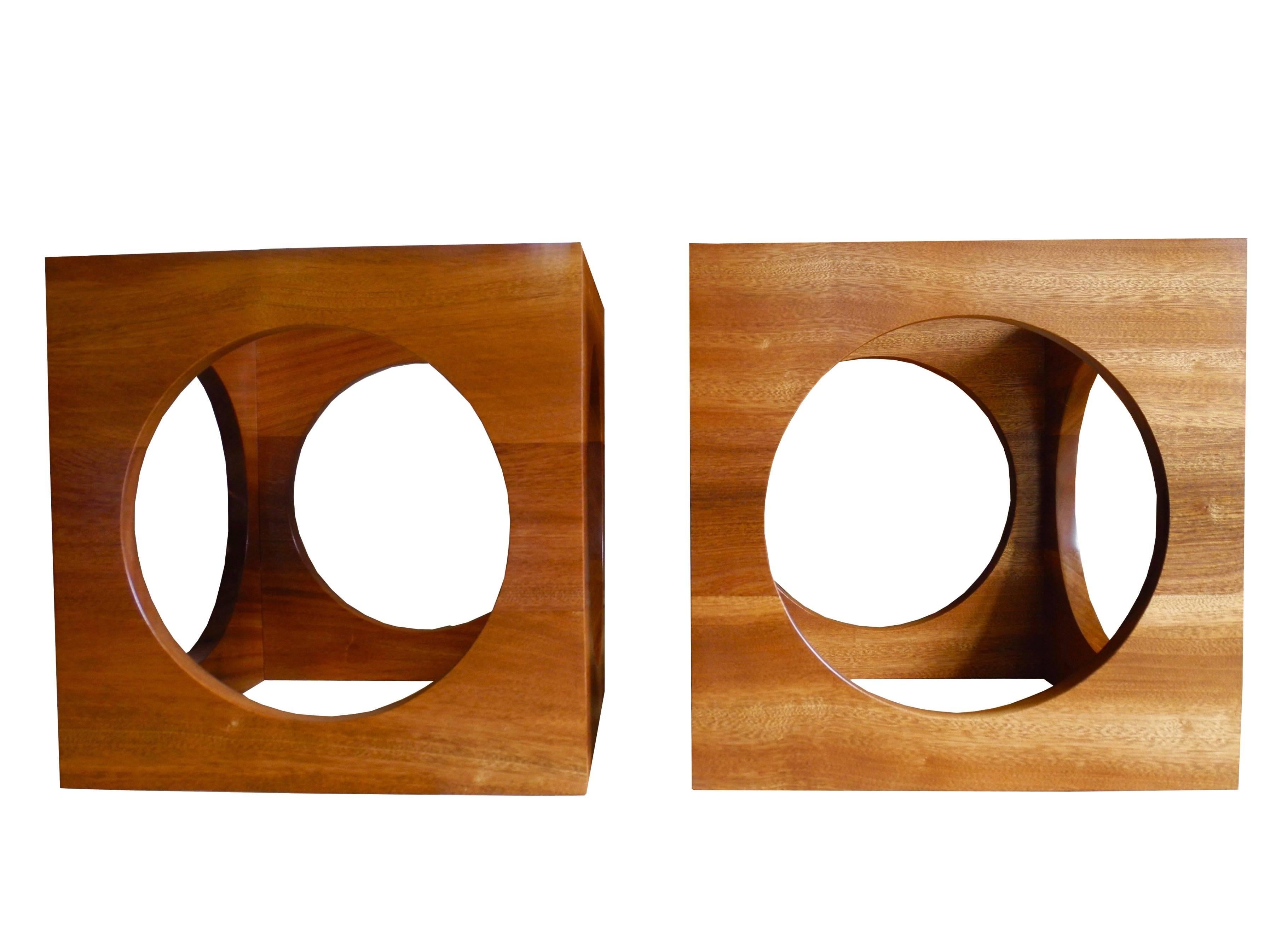 This pair of open cubed side tables or (put them together to make a coffee table) are made of African mahogany also known as Sapele wood. They make great nightstands too. These tables come with clear glass tops; designed by Corinne Robbins, 2017.