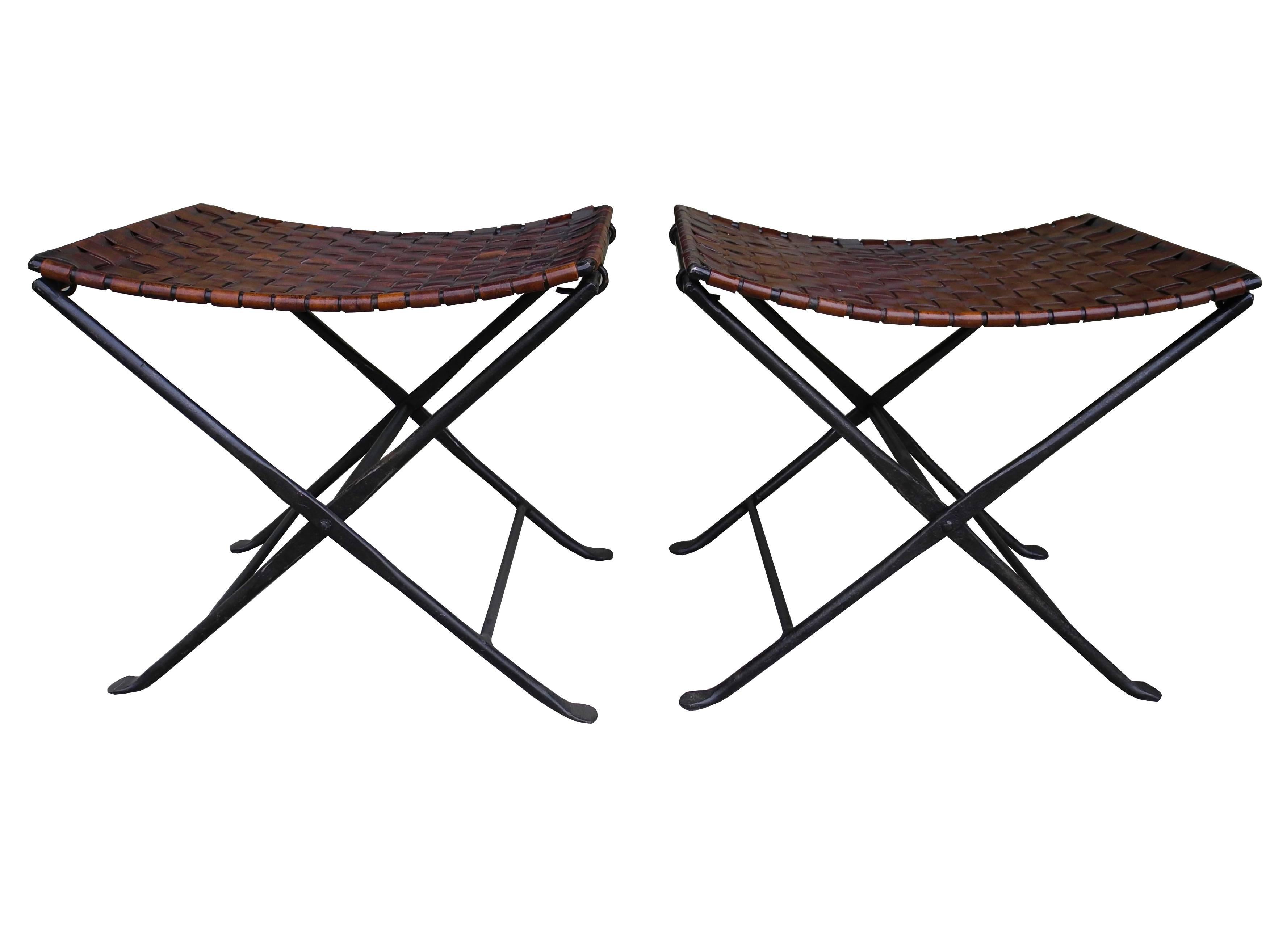 These stools were handcrafted made of forged wrought iron and woven strips of brown saddle leather.