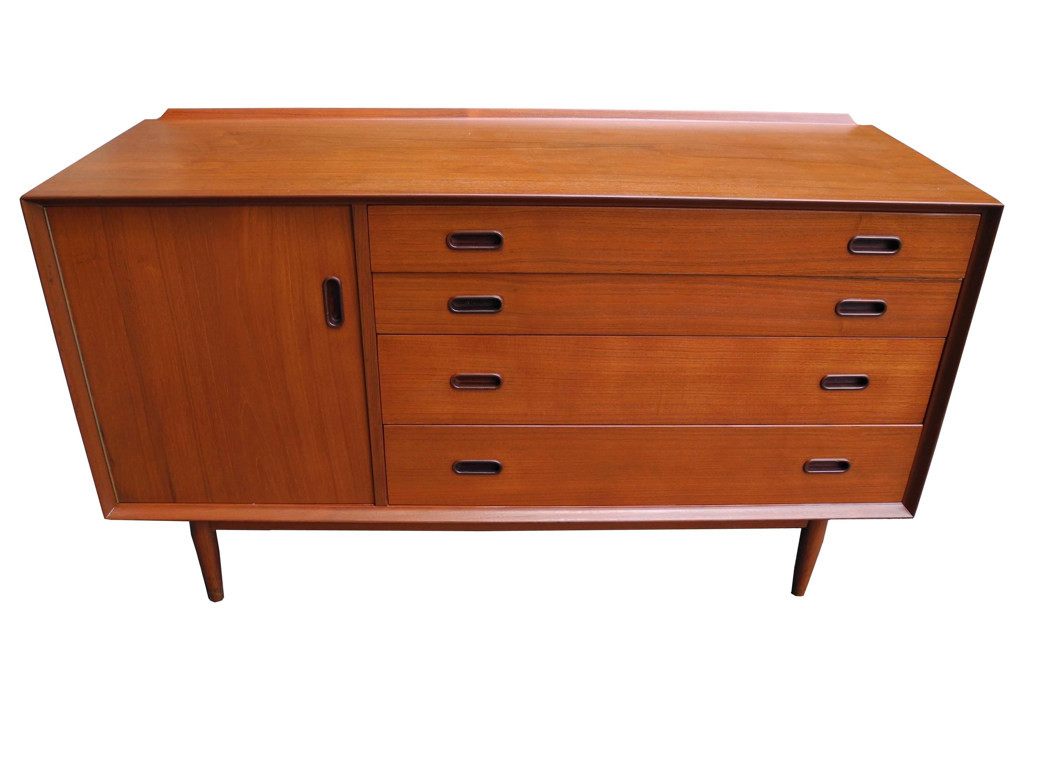 This case piece with four drawers and a side cabinet functions as a credenza, dresser or sideboard. It is a great storage piece for any room. The grain in the teakwood is beautiful and the overall condition is excellent for a vintage piece.
Notice