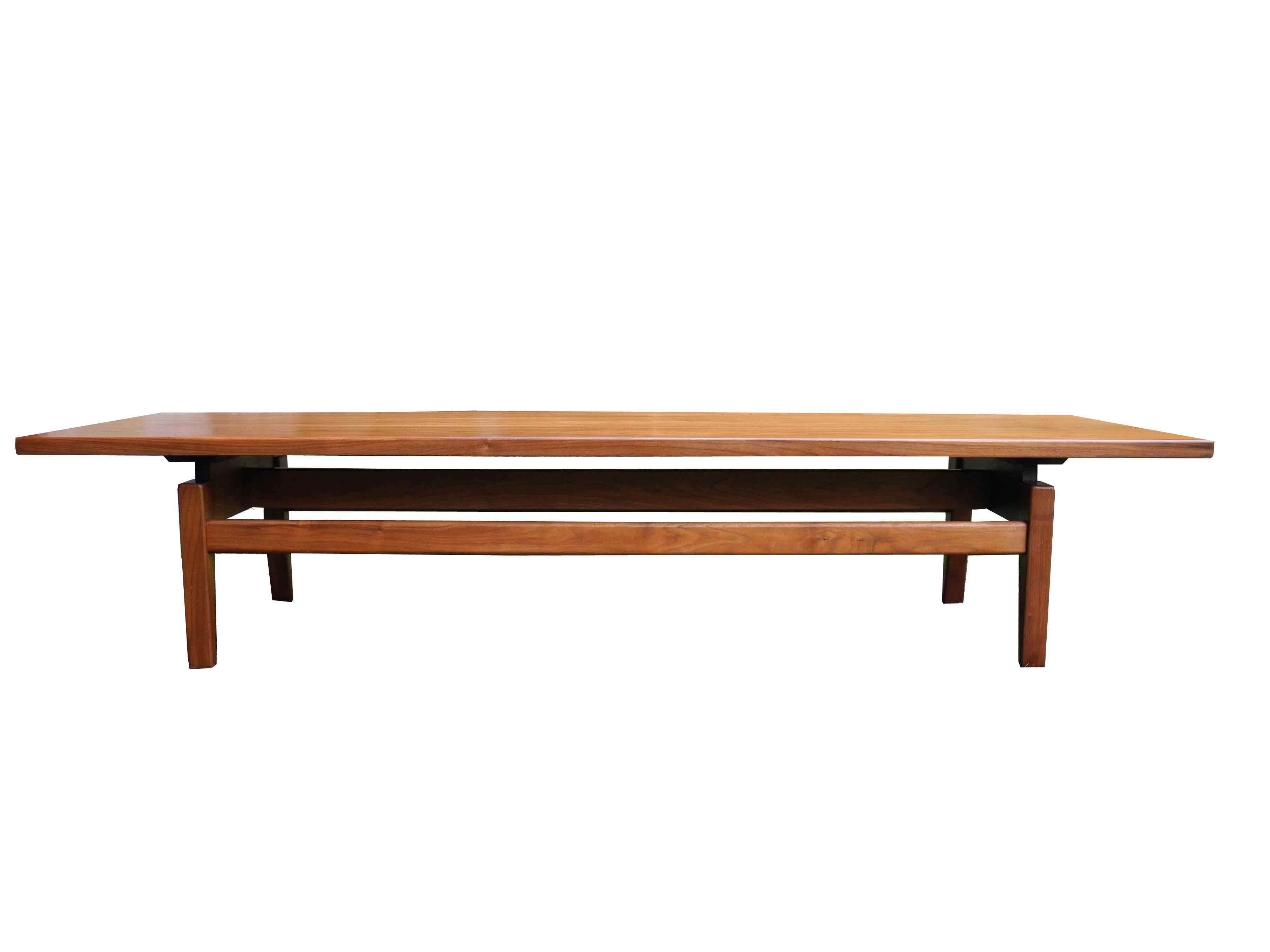 This walnut coffee table is made of solid wood. The natural finish on the wood brings out the beauty of the grain and the true color of the walnut. This original vintage bench was made in the 1950s by Jens Risom the Danish American furniture