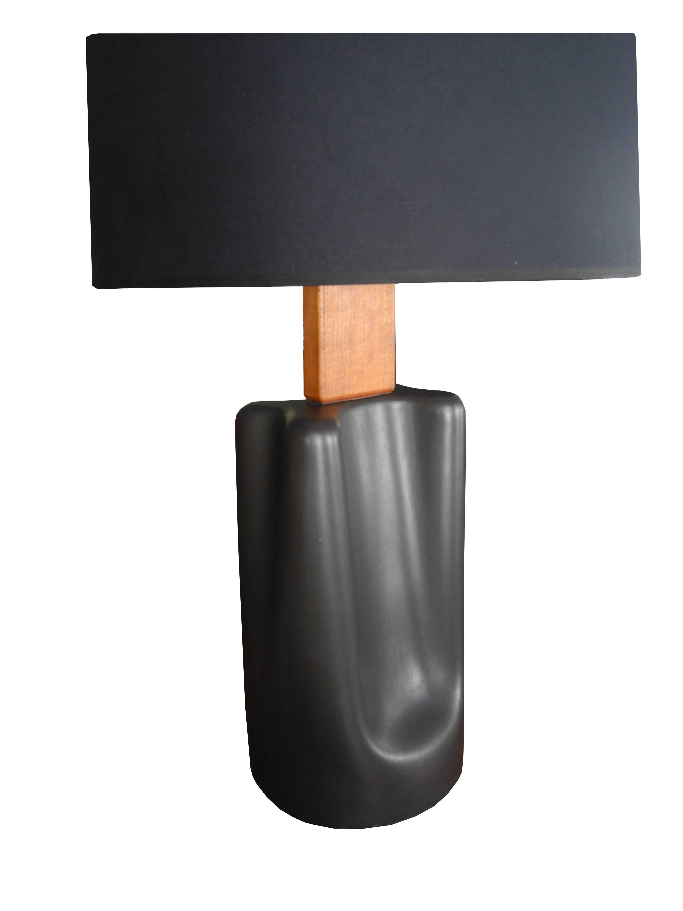 This beautifully shaped and exquisitely glazed in gray gun-metal, ceramic lamp, is topped with a block of solid teak at the neck. Beautiful lines, shape and use of different materials. The height of 31