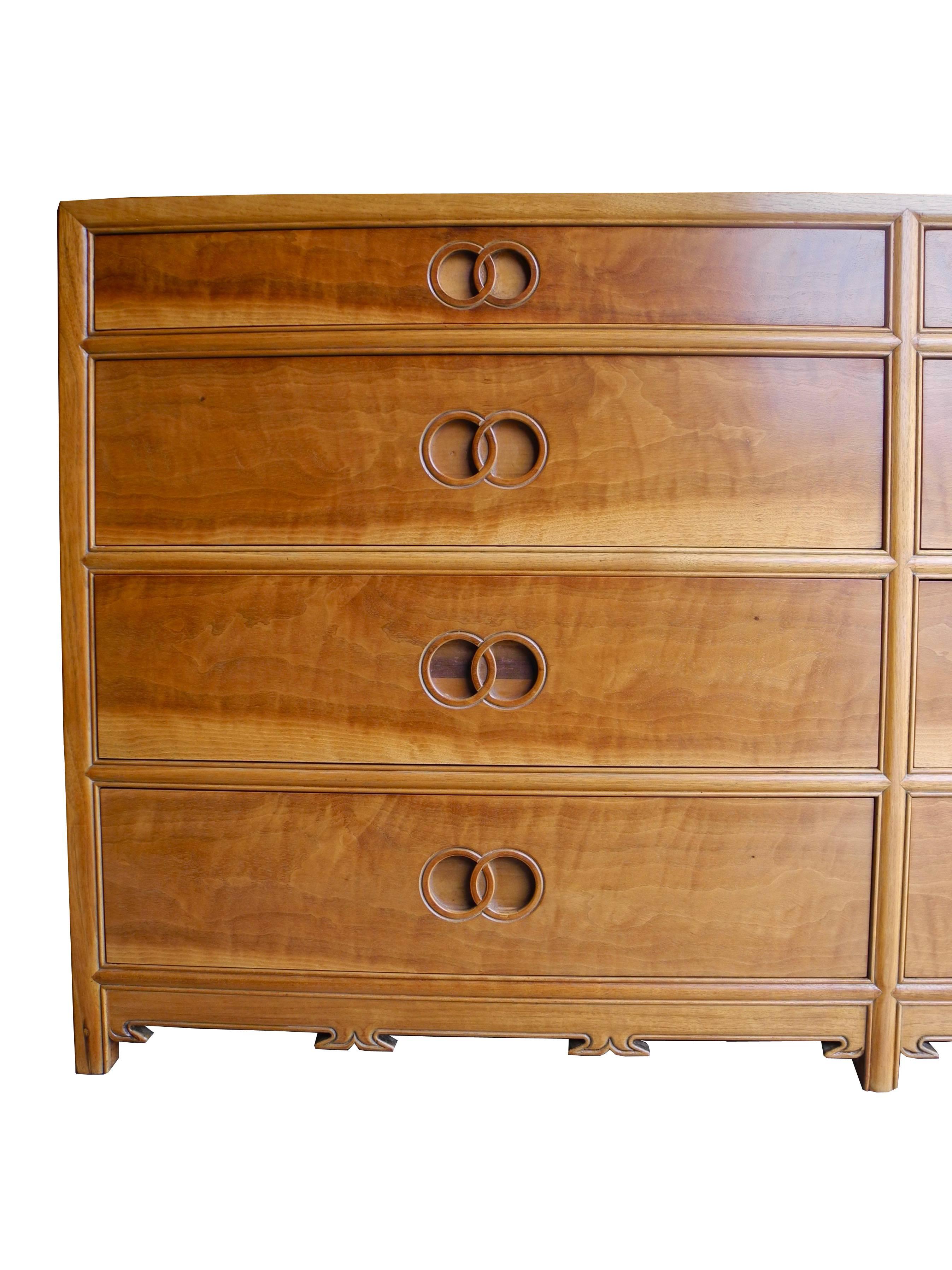 This lovely two bank dresser with eight drawers made of natural light walnut is designed by Michael Taylor. It has just the right amount of details in the base and handles.