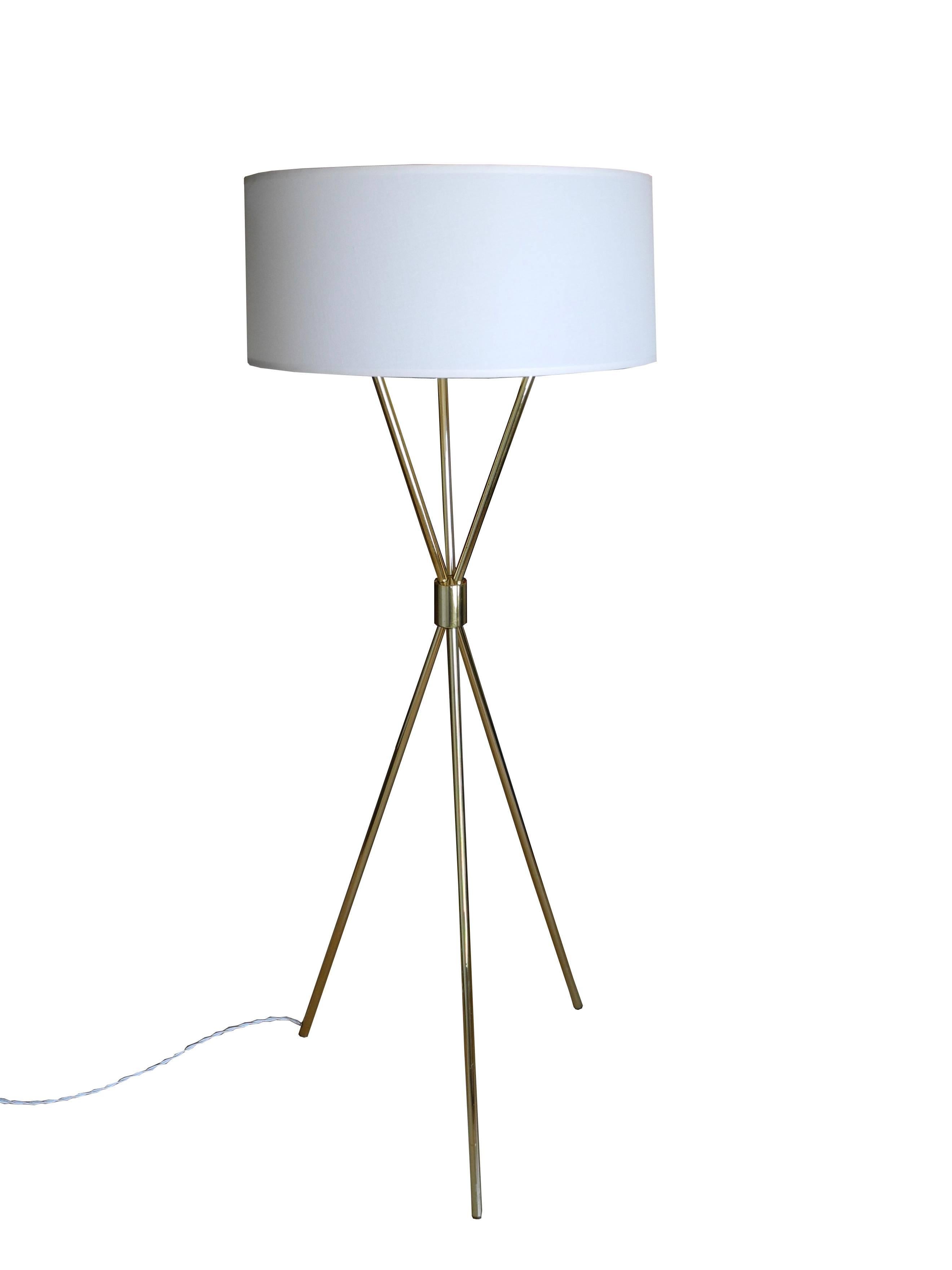 This solid brass floor lamp is topped with a white linen shade measuring 7