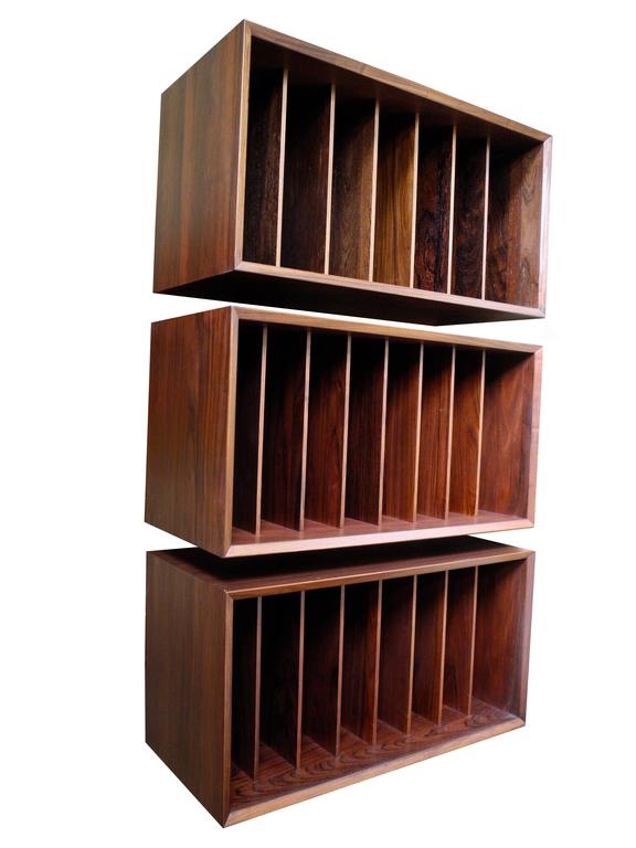 This Poul Cadovious for Cado rosewood wall unit consists of three case pieces or shelving parts. Use for books or vinyl records. Hanging rods included. Very simple to install. Height may vary depending on spread of shelves. Made in Denmark.