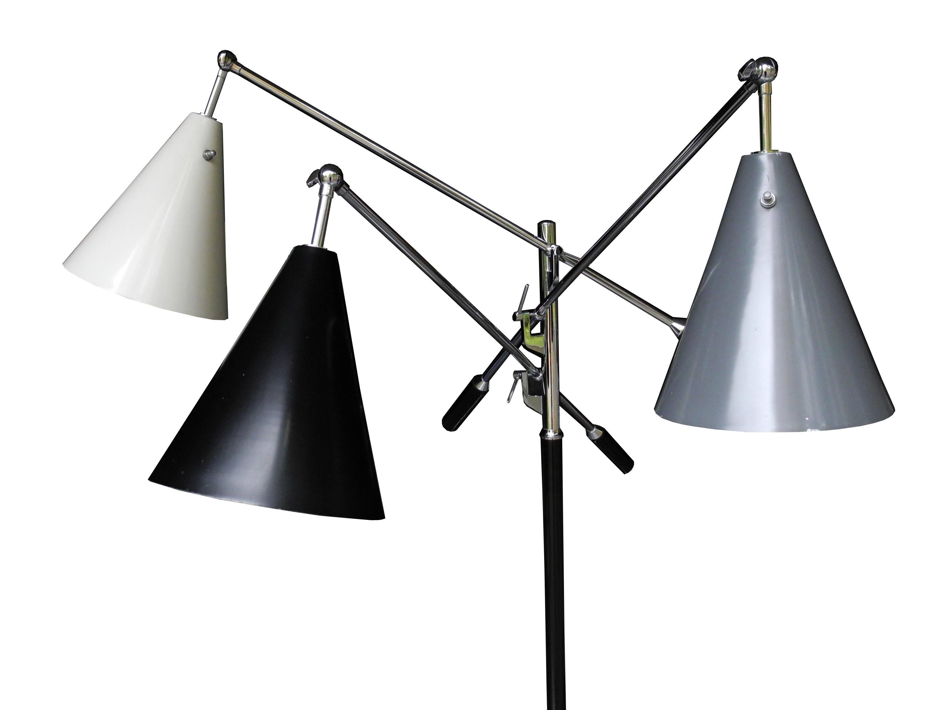 This three-arm, chrome and leather with marble base, floor lamp has adjustable arms and adjustable shades. The shades are spun aluminium all in original condition, black white and gray. The sockets have new wire. Measurements fluctuate according to