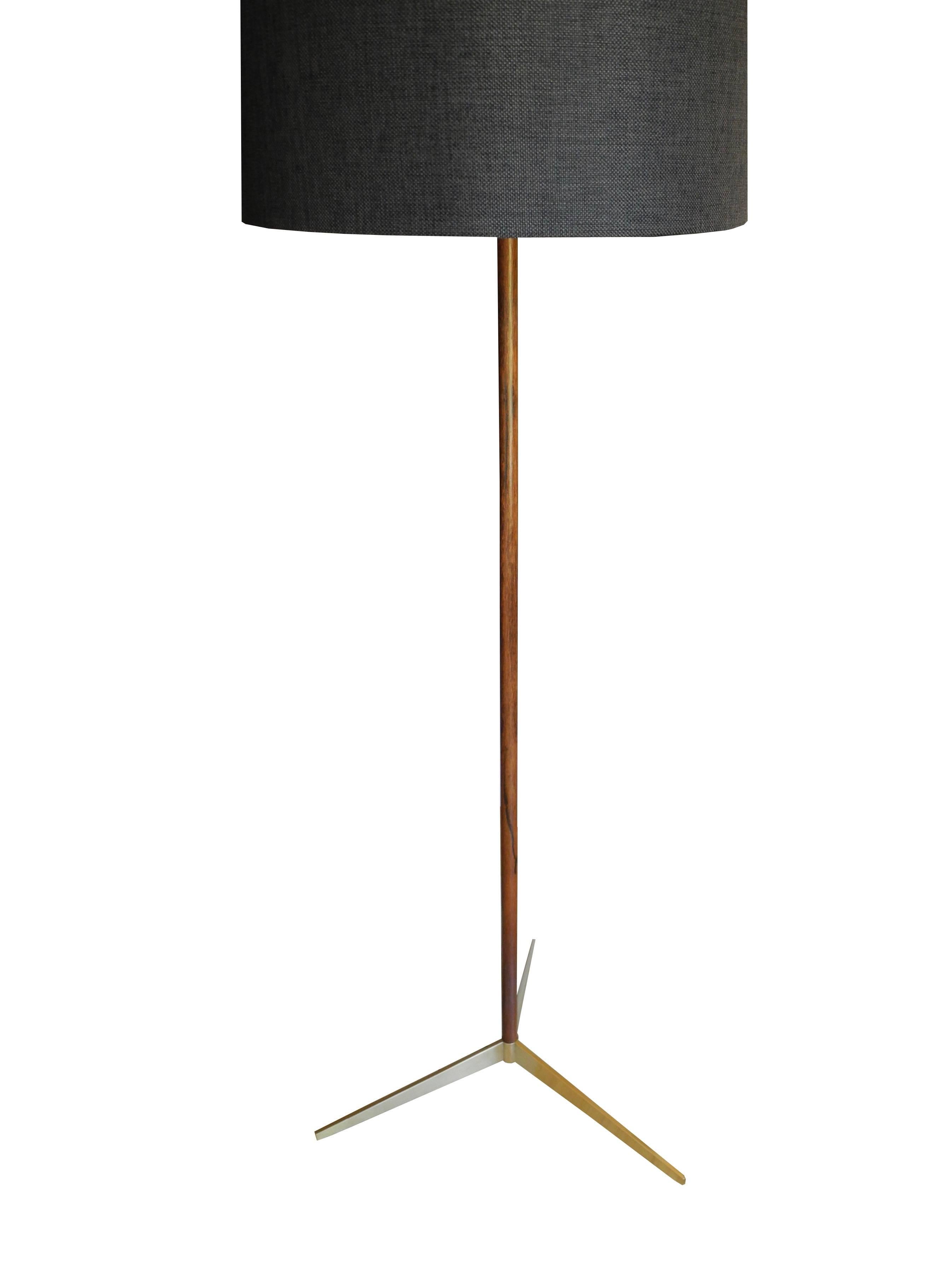 Super sleek and simple modern rosewood stem and brass tripod base with a charcoal drum shade.