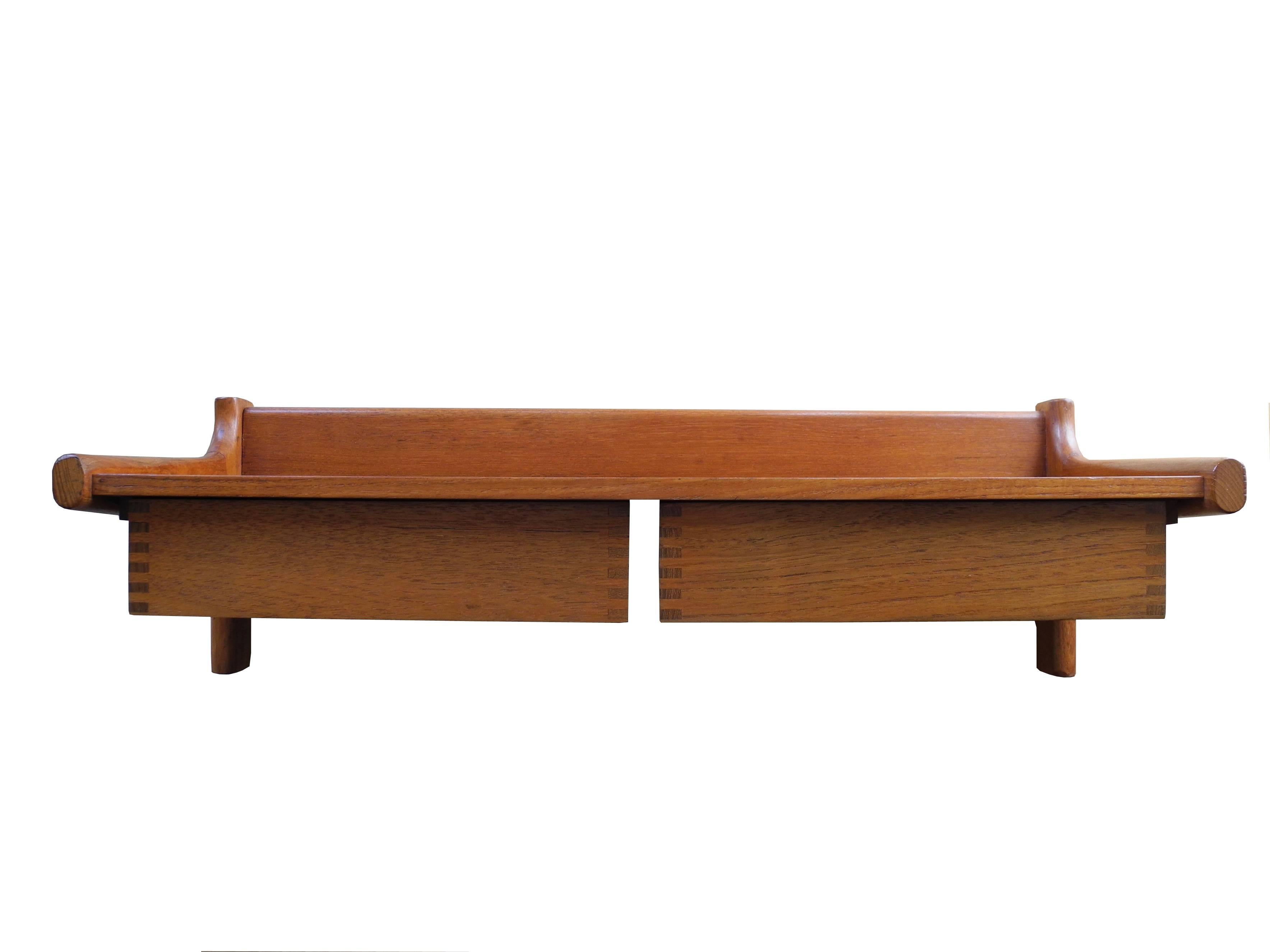 This teak double drawer bedside shelf is a Danish design by Børge Mogensen. It hangs on the wall so it can be adjusted at any height. There is a matching single drawer available as well. See photos.
 