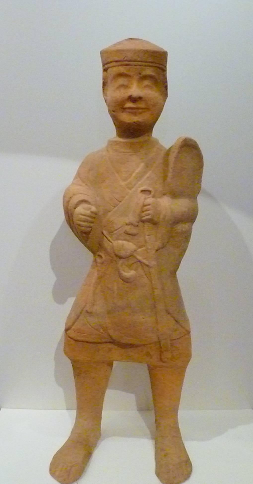 An elegant statue of standing guardian, benevolent facial expression, fine details, Han dynasty 206BC-220AD. Come with Oxford TL test certificate.